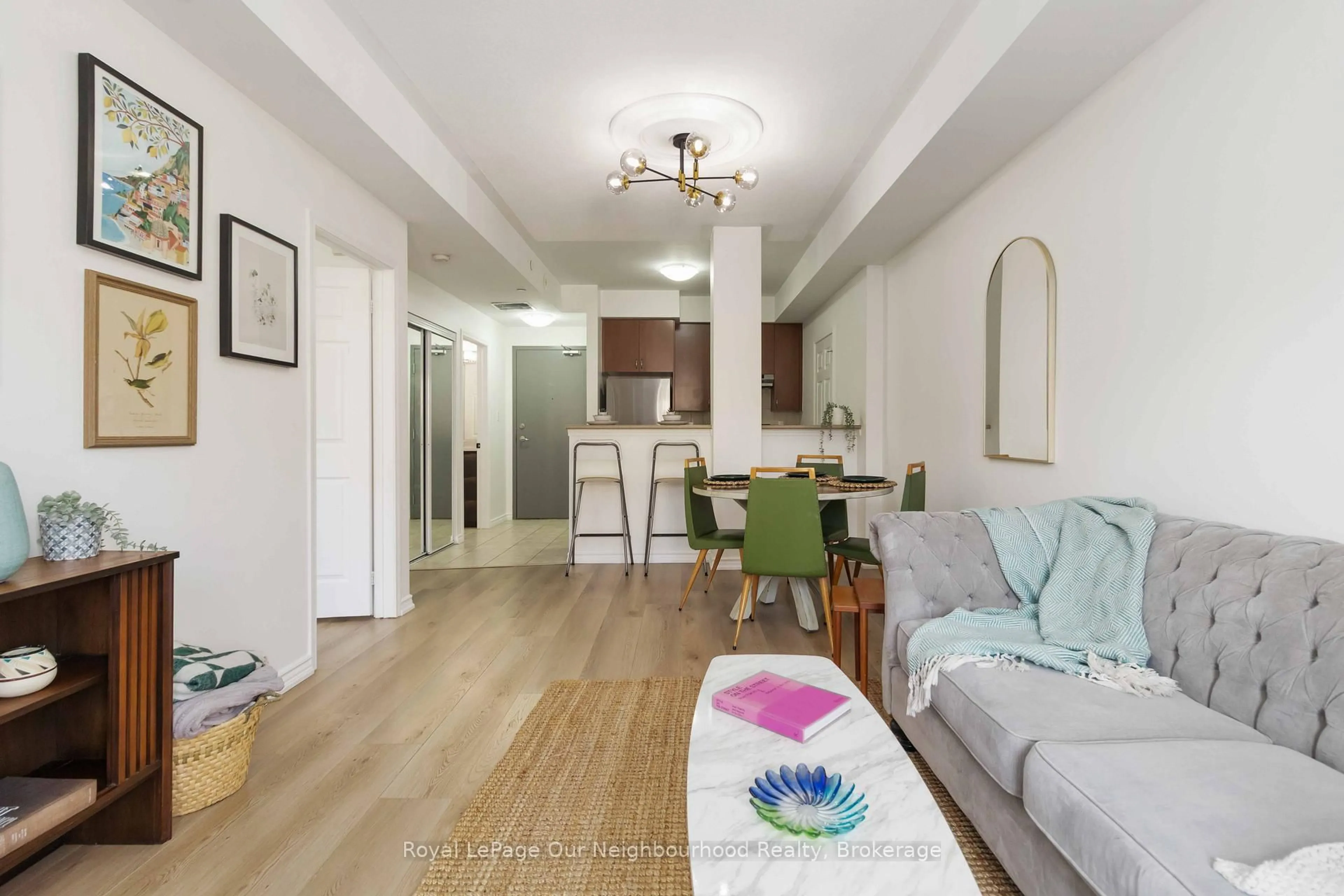 Living room with furniture, wood/laminate floor for 3075 Thomas St #201, Mississauga Ontario L5M 0L4