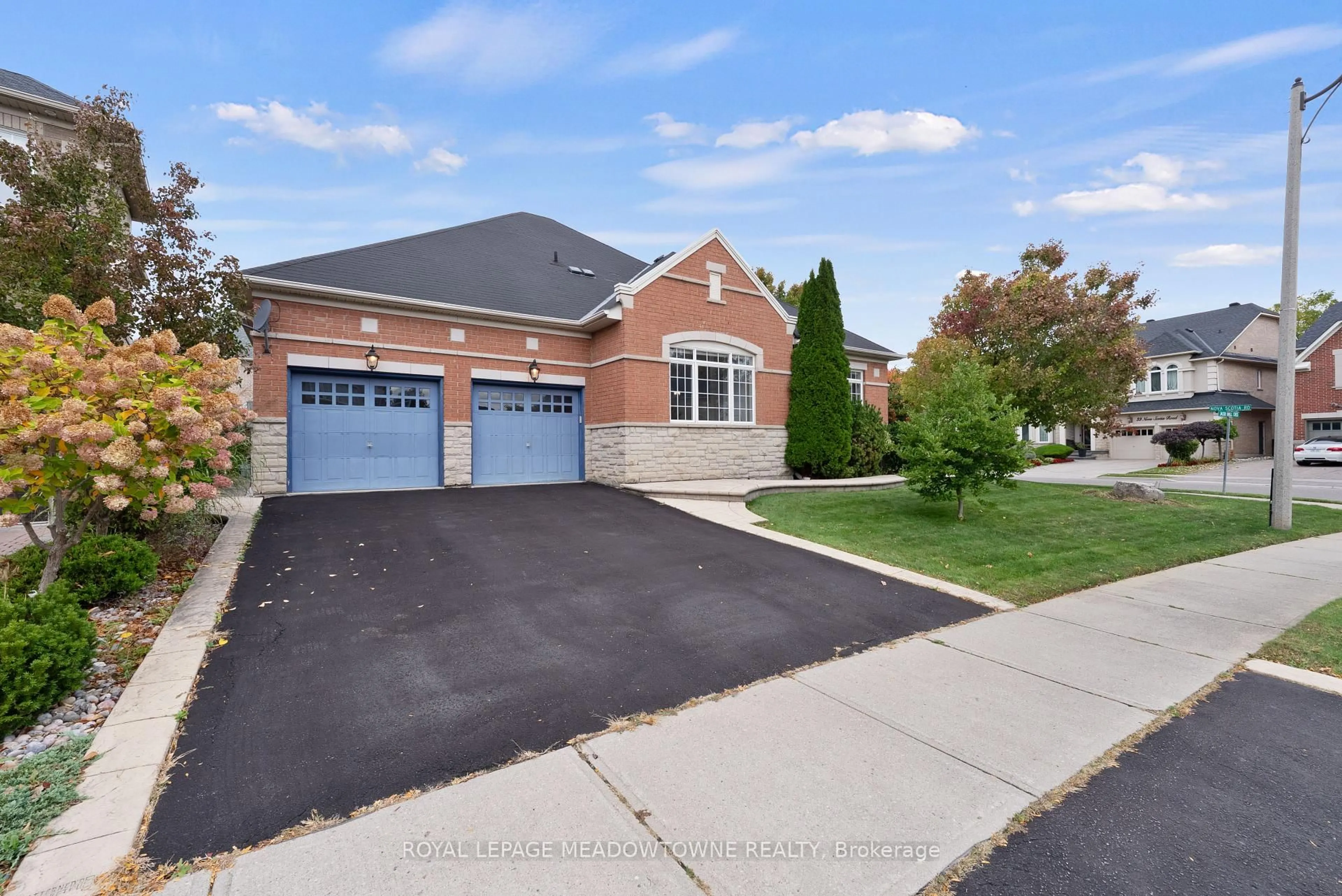 Home with brick exterior material, street for 32 Nova Scotia Rd, Brampton Ontario L6Y 5K5