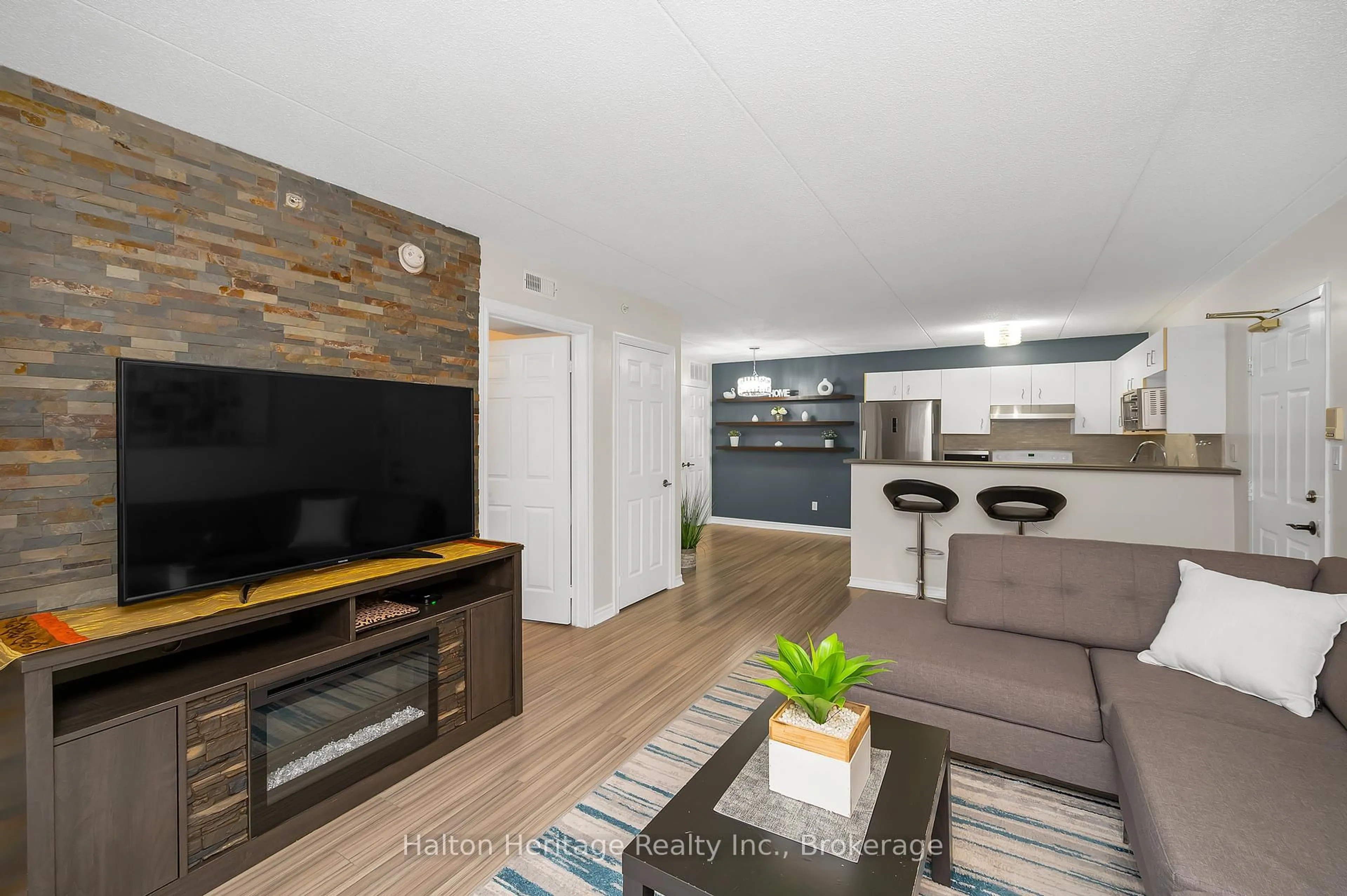 Living room with furniture, wood/laminate floor for 4015 Kilmer Dr #110, Burlington Ontario L7M 4M4