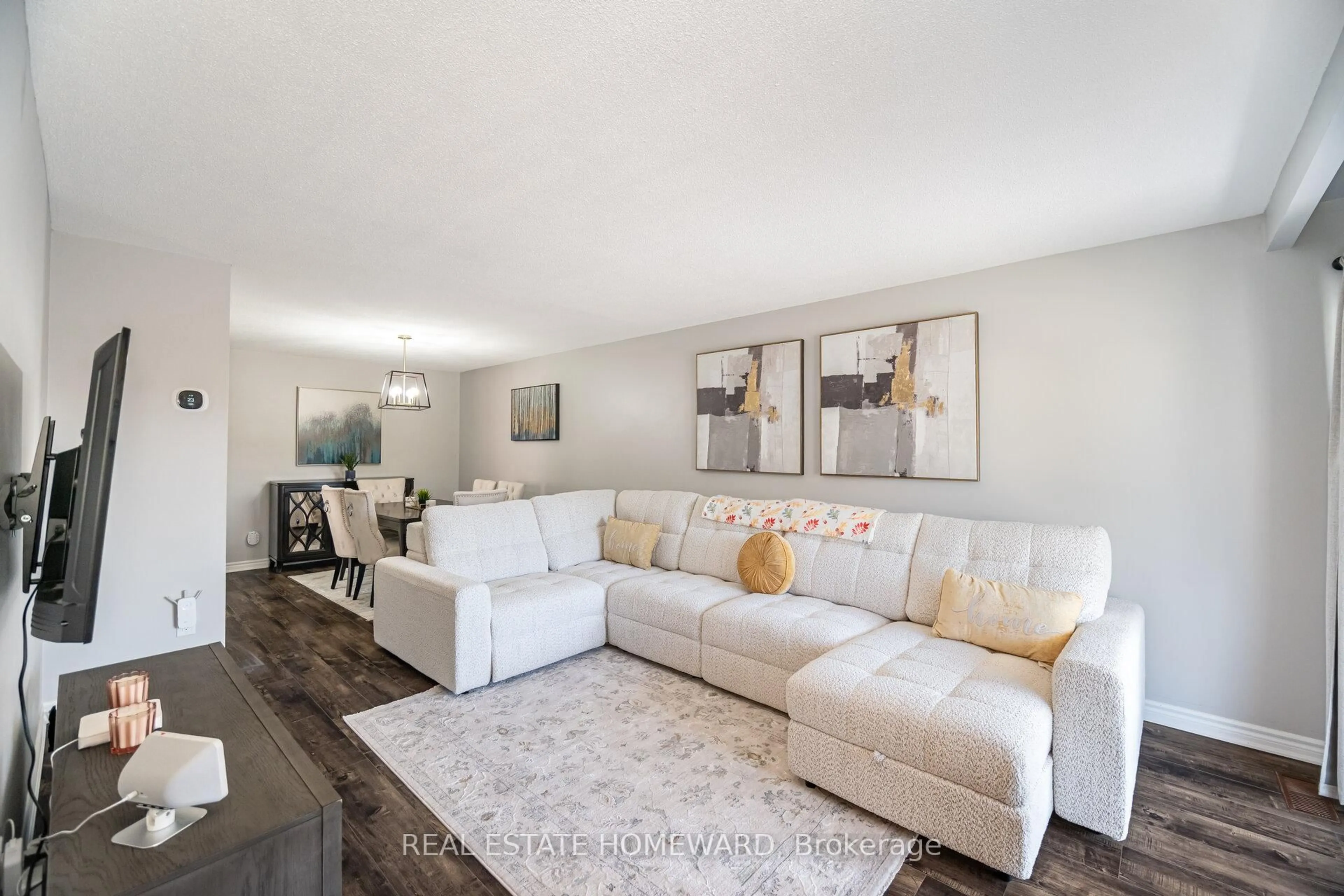 Living room with furniture, wood/laminate floor for 309 Royal Salisbury Way, Brampton Ontario L6V 3G4