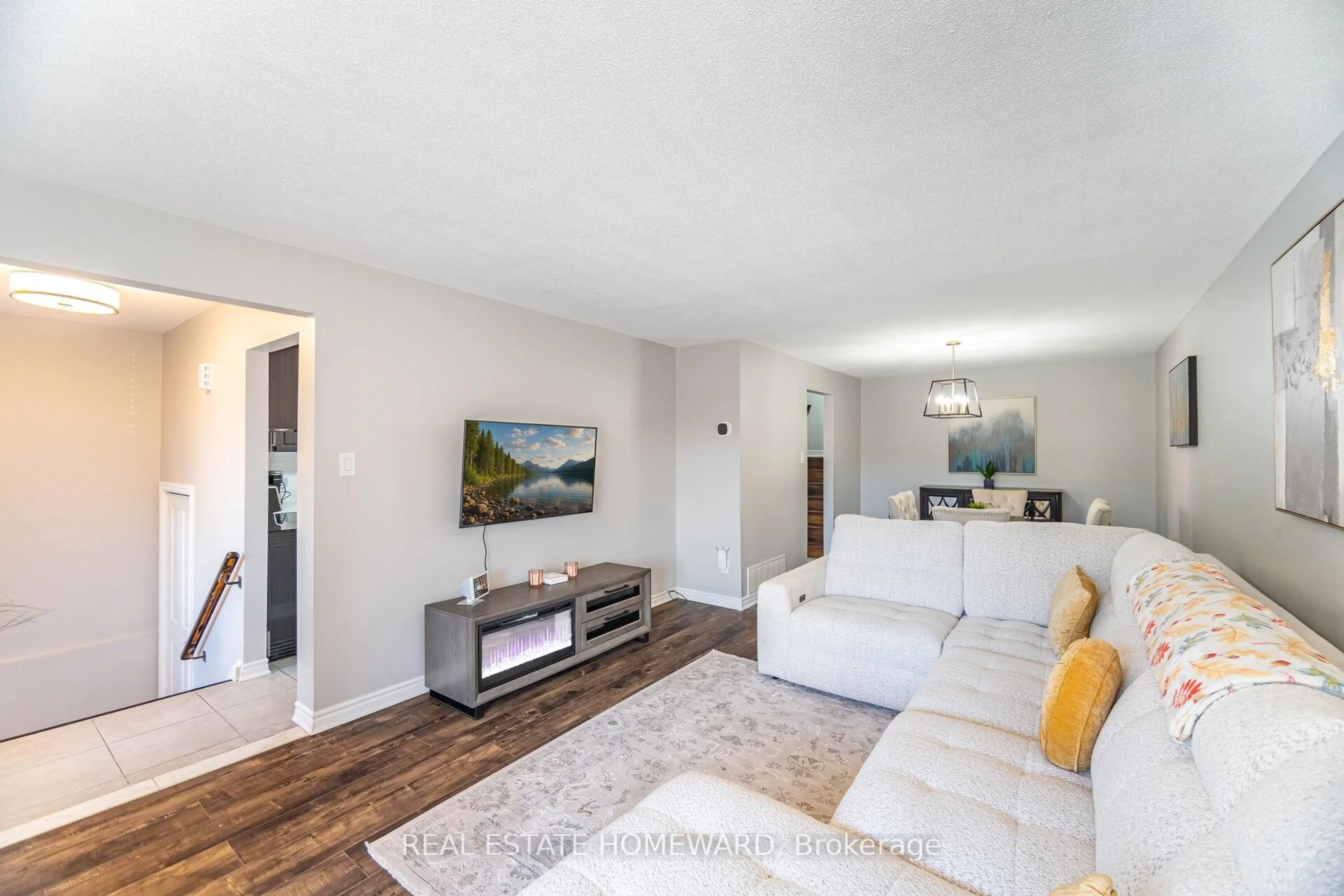 Living room with furniture, wood/laminate floor for 309 Royal Salisbury Way, Brampton Ontario L6V 3G4