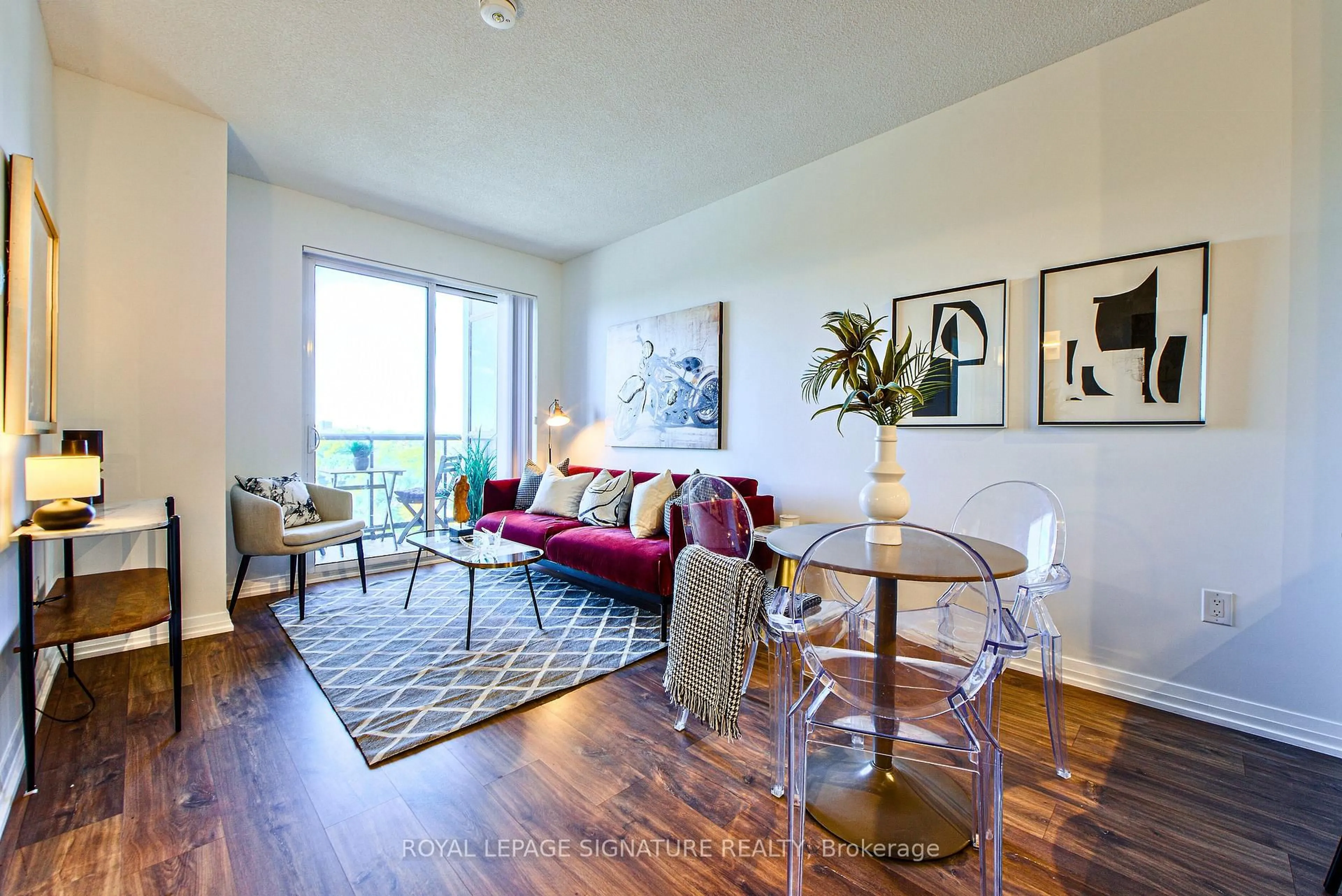 Living room with furniture, wood/laminate floor for 50 Thomas Riley Rd #714, Toronto Ontario M9B 0C5