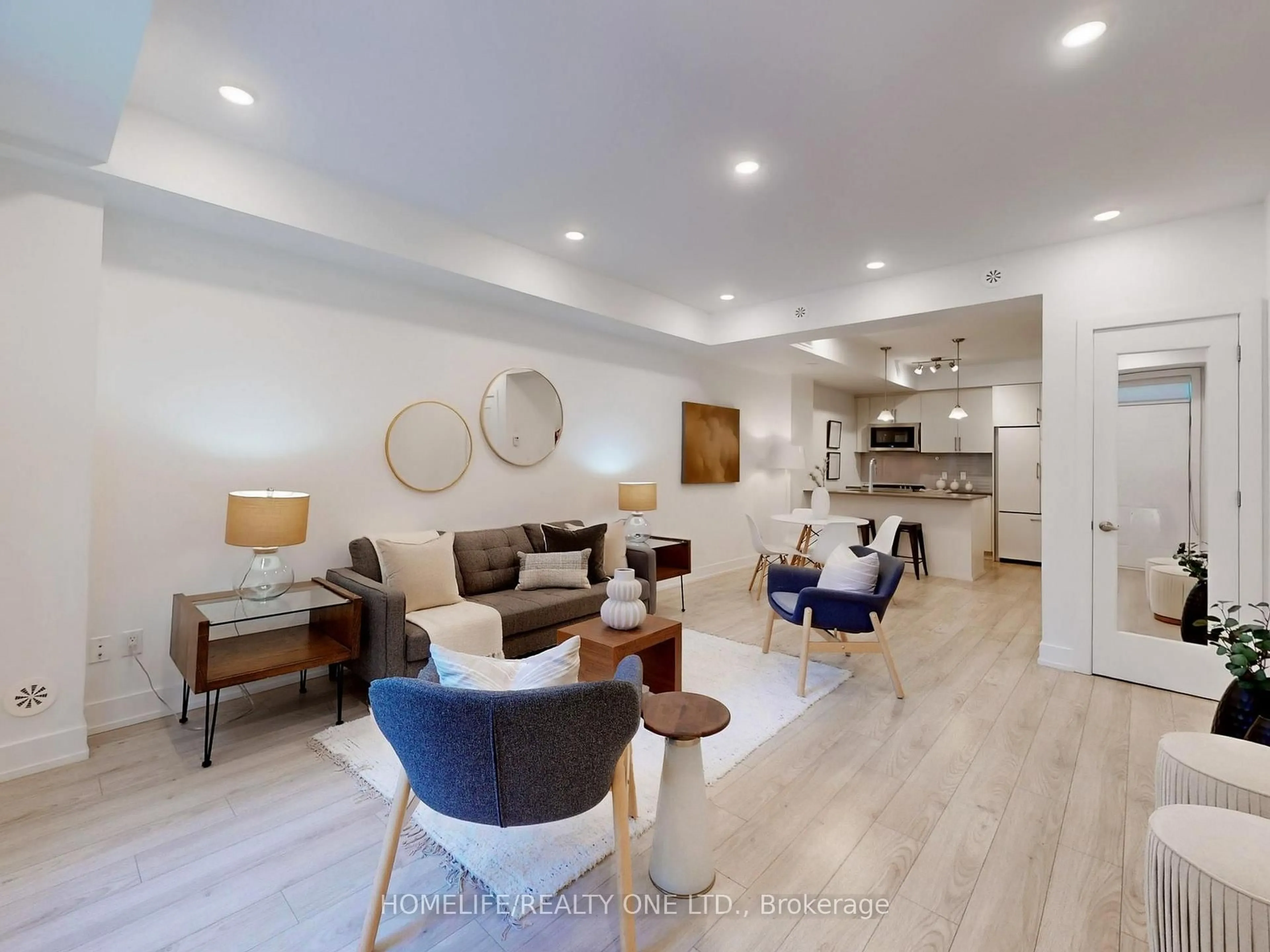 Living room with furniture, wood/laminate floor for 3 Elsie Lane #TH 41, Toronto Ontario M6P 0B8