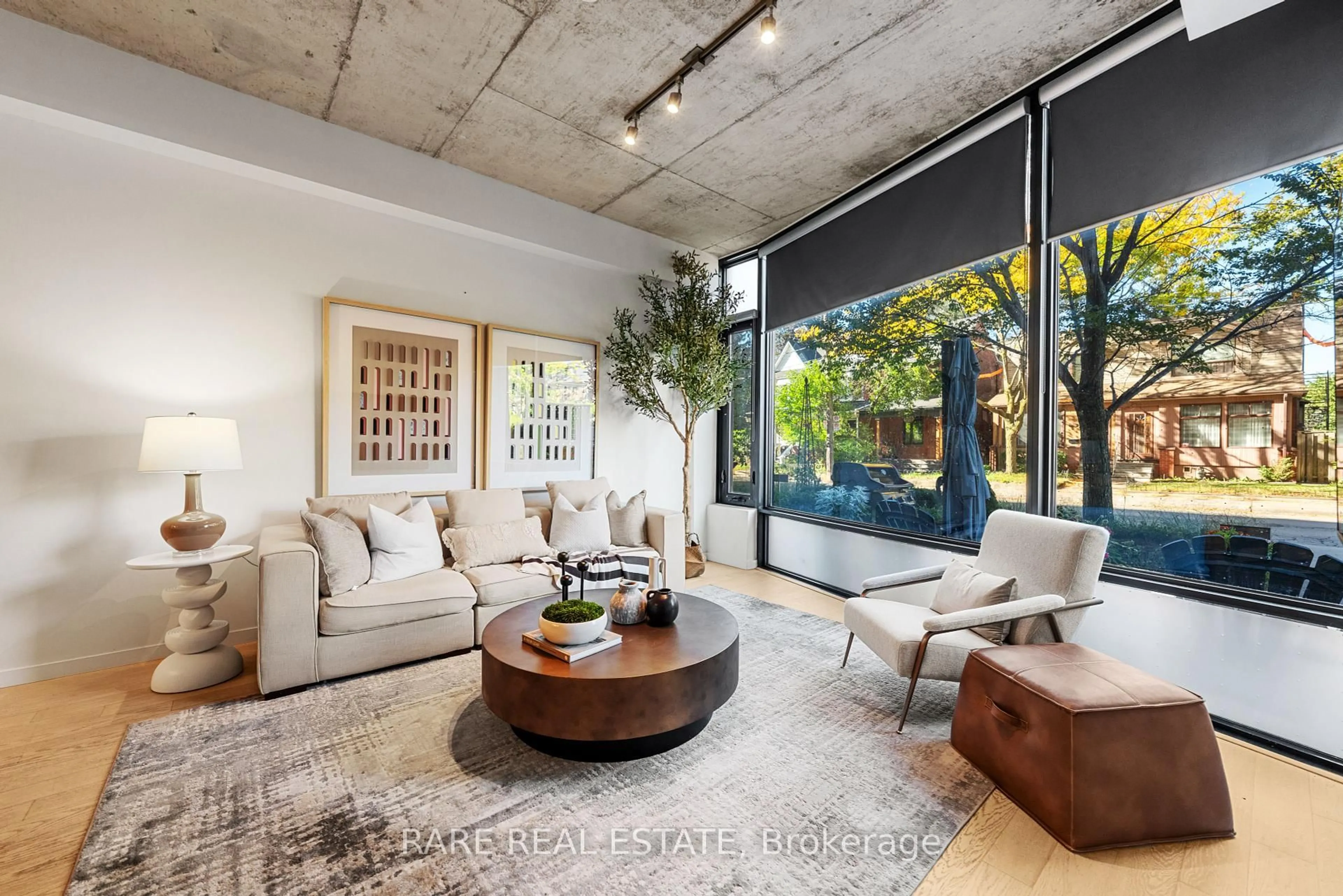 Living room with furniture, cement floor for 377 Sorauren Ave, Toronto Ontario M6R 0A4