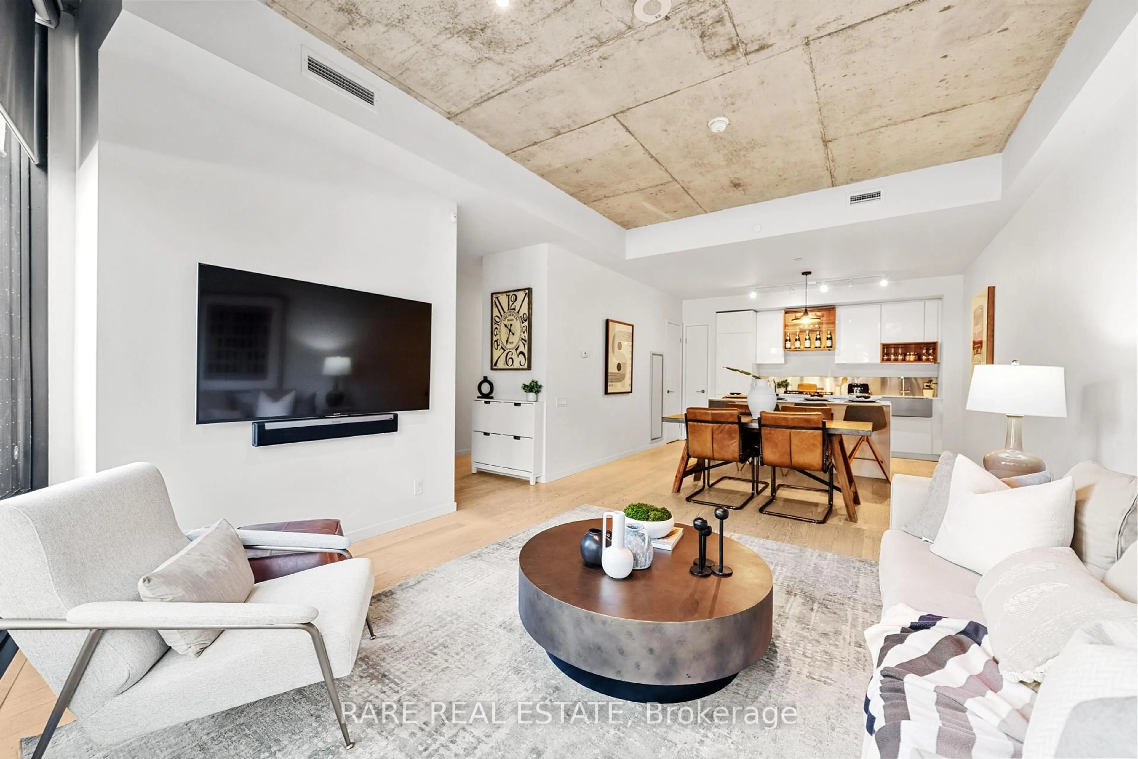 Living room with furniture, cement floor for 377 Sorauren Ave #102, Toronto Ontario M6R 0A4