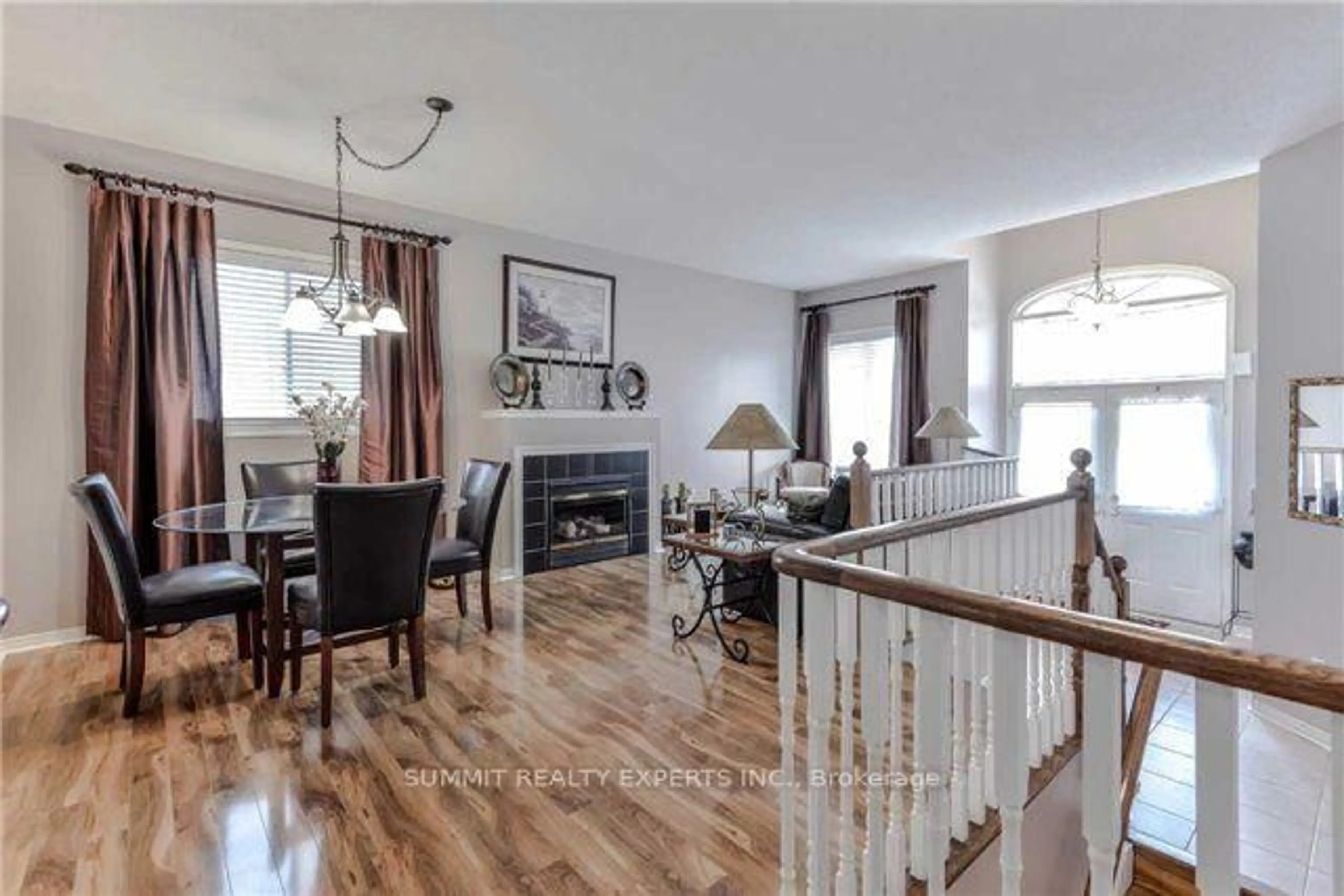 Living room with furniture, wood/laminate floor for 23 Bissell Dr, Brampton Ontario L7A 3K1