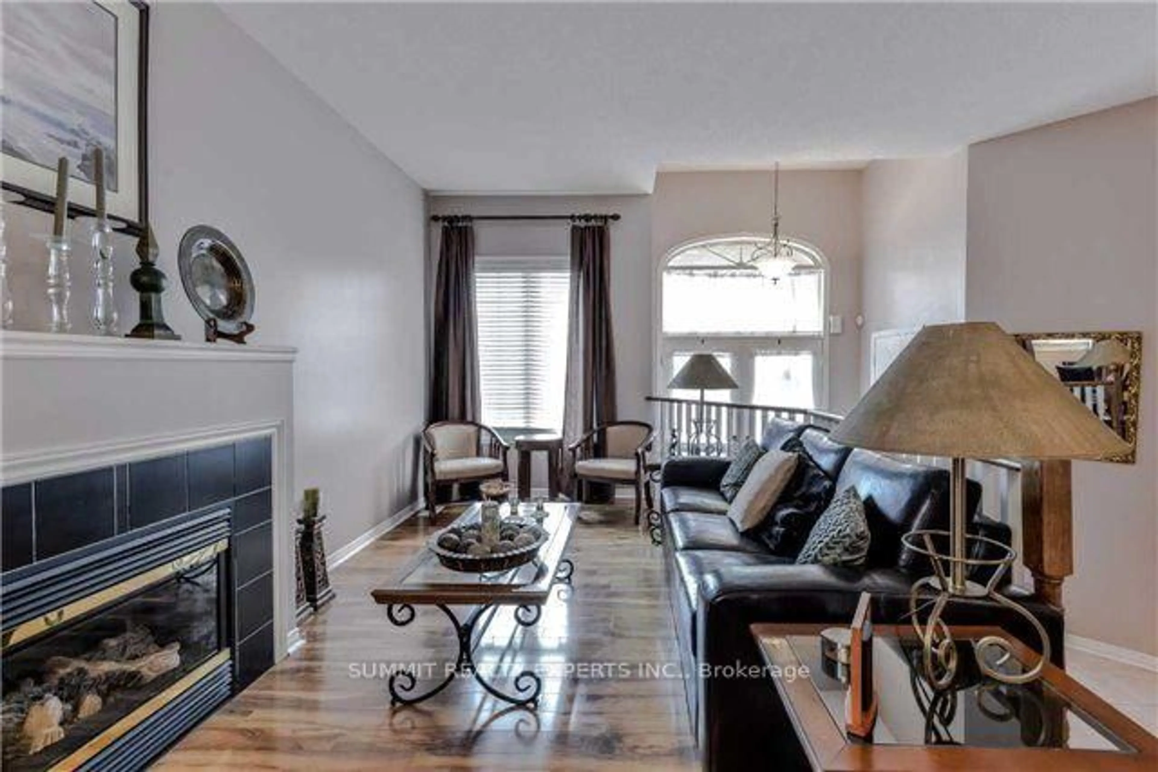 Living room with furniture, wood/laminate floor for 23 Bissell Dr, Brampton Ontario L7A 3K1