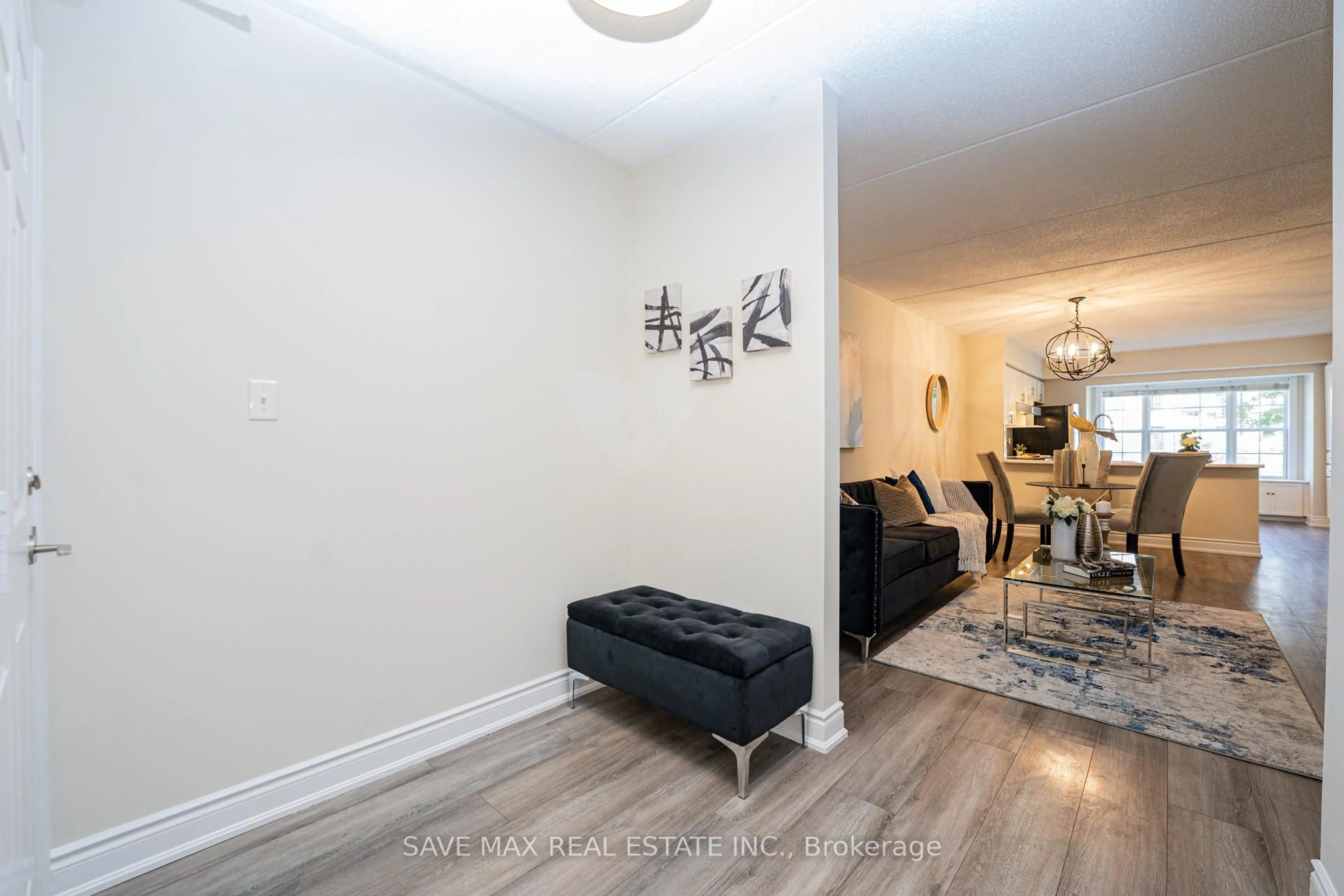 Living room with furniture, wood/laminate floor for 1491 Maple Ave #111, Milton Ontario L9T 0B8
