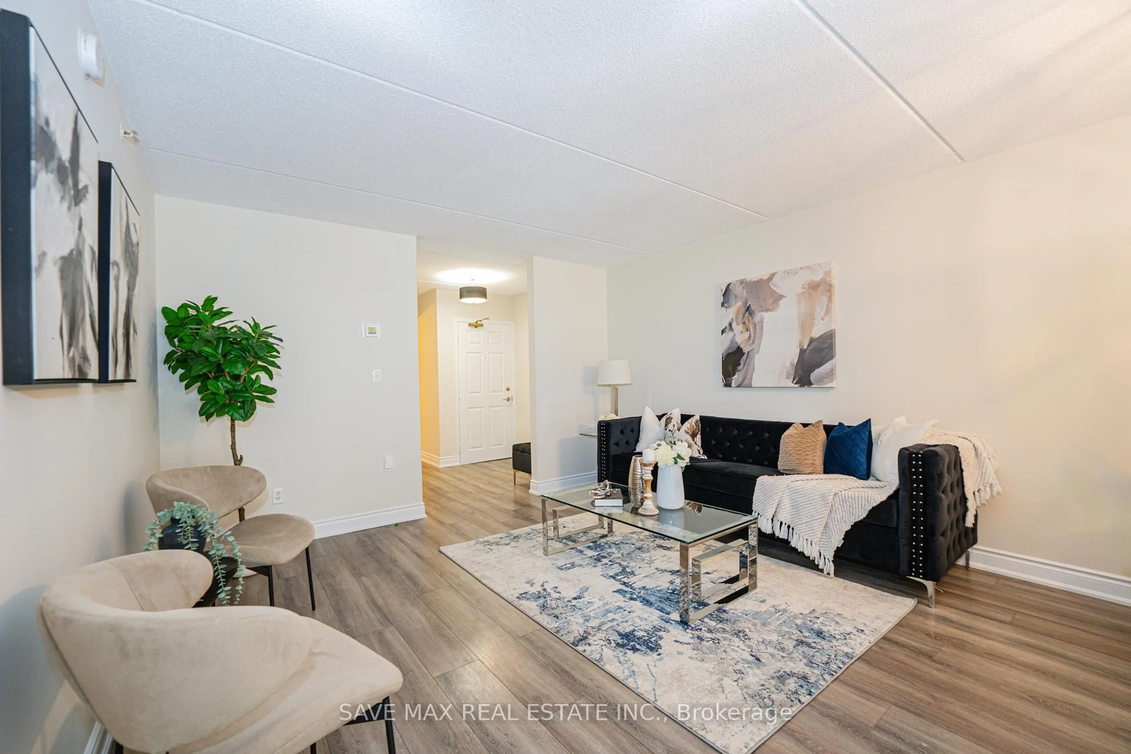 Living room with furniture, wood/laminate floor for 1491 Maple Ave #111, Milton Ontario L9T 0B8