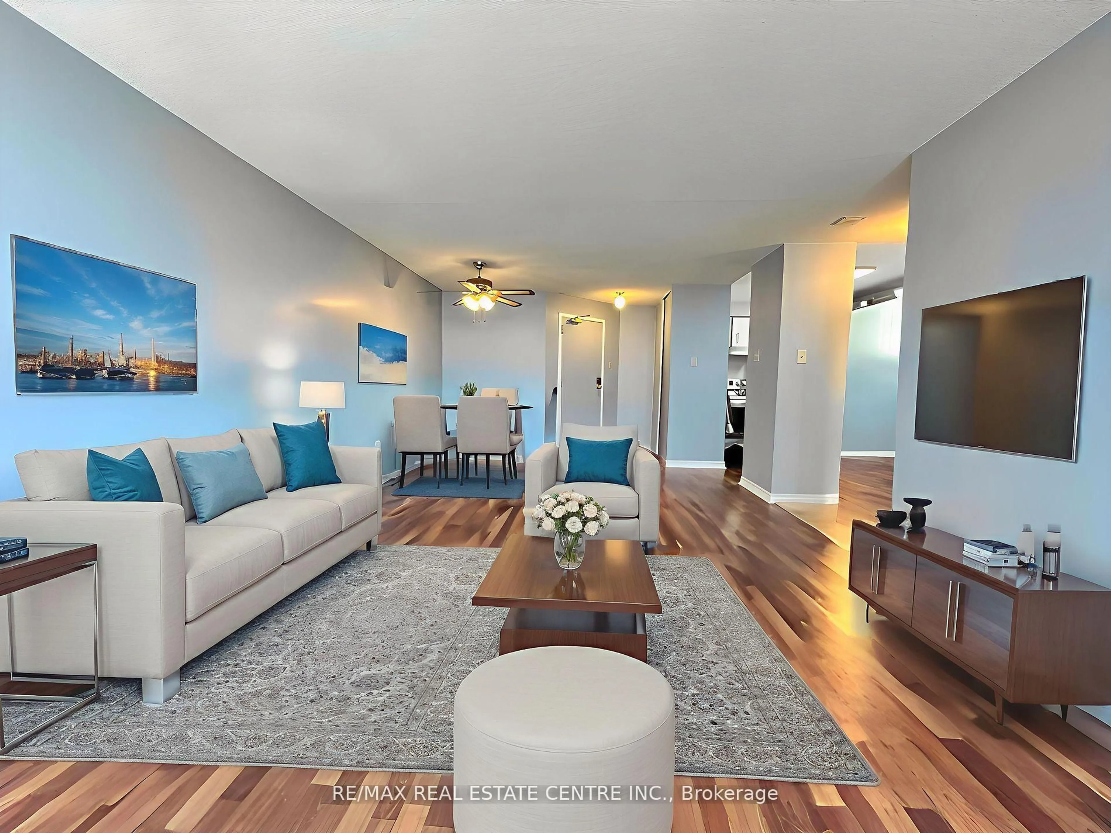 Living room with furniture, wood/laminate floor for 25 Trailwood Dr #PH5, Mississauga Ontario L4Z 3K9