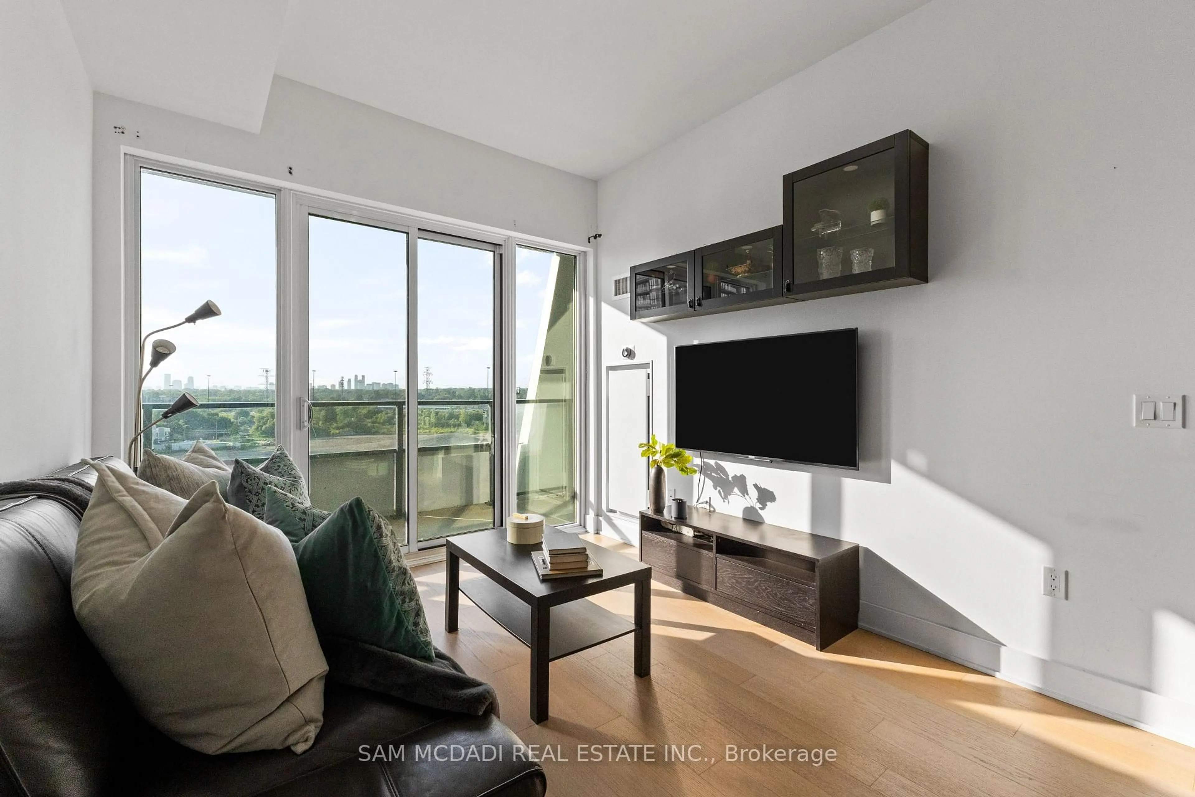 Living room with furniture, wood/laminate floor for 30 Shore Breeze Dr #1012, Toronto Ontario M8V 1A1