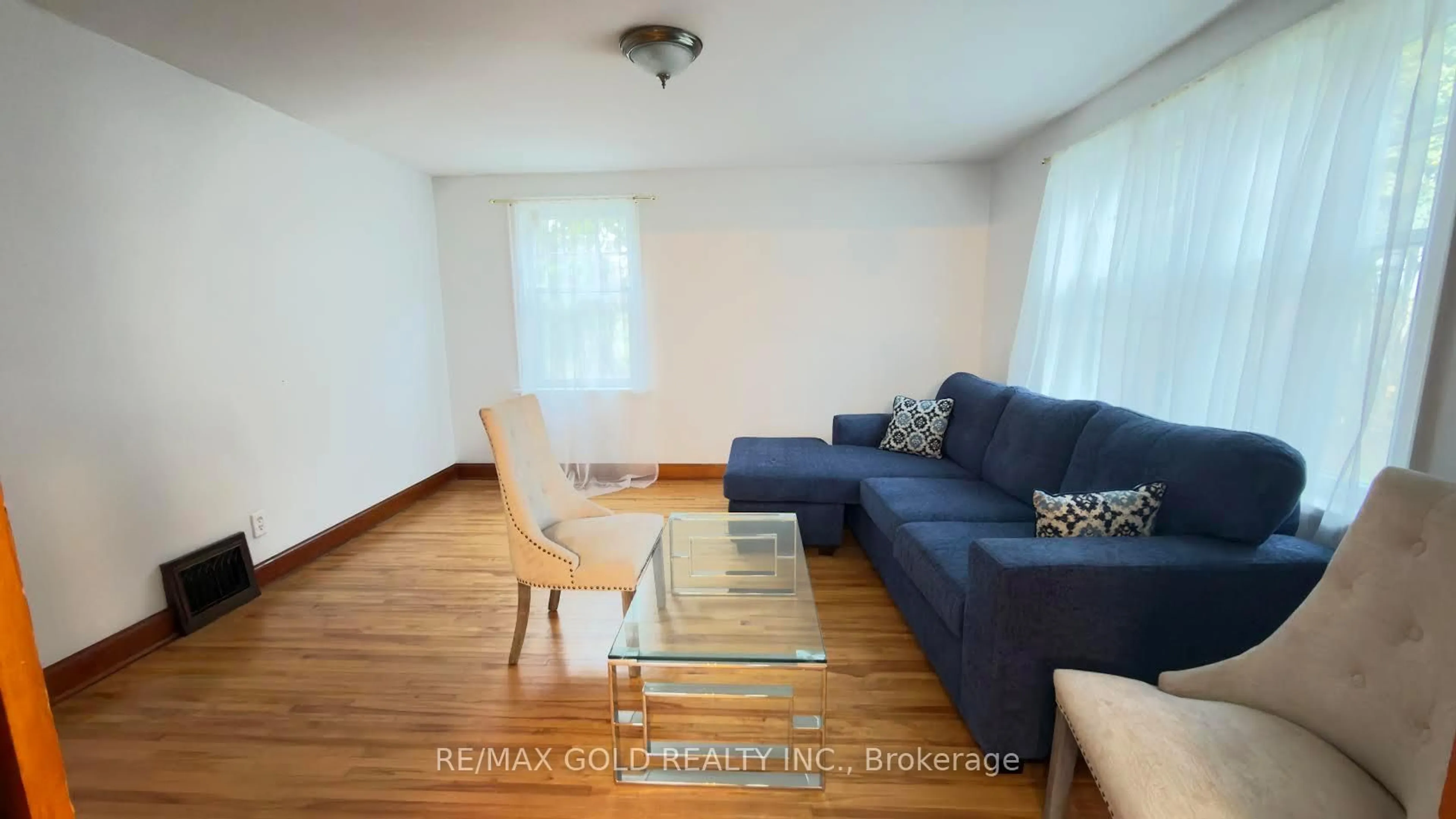 Living room with furniture, wood/laminate floor for 8790 Trafalgar Rd, Halton Hills Ontario L7G 4S5