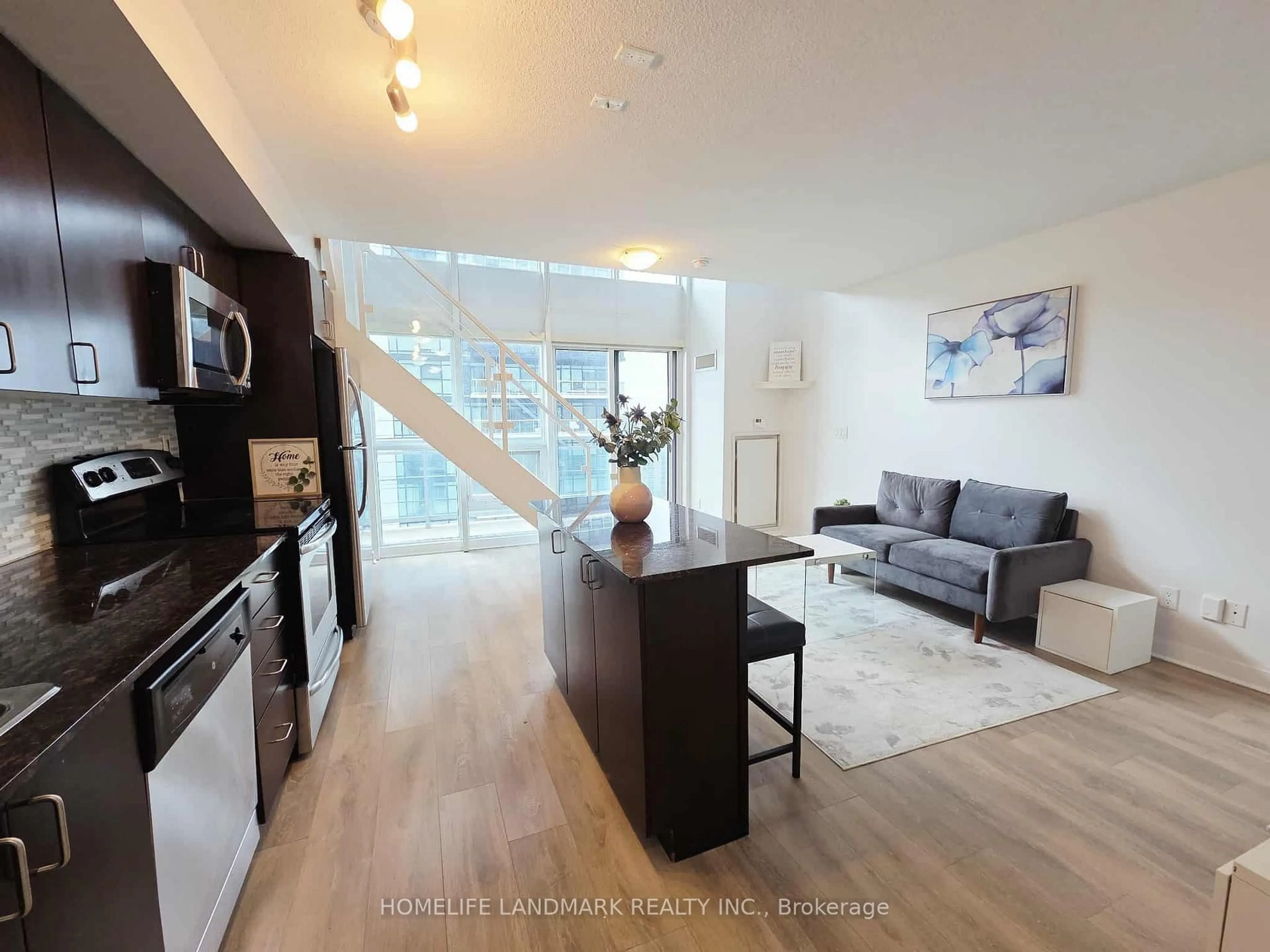 Living room with furniture, wood/laminate floor for 155 Legion Rd #1706, Toronto Ontario M8Y 0A7