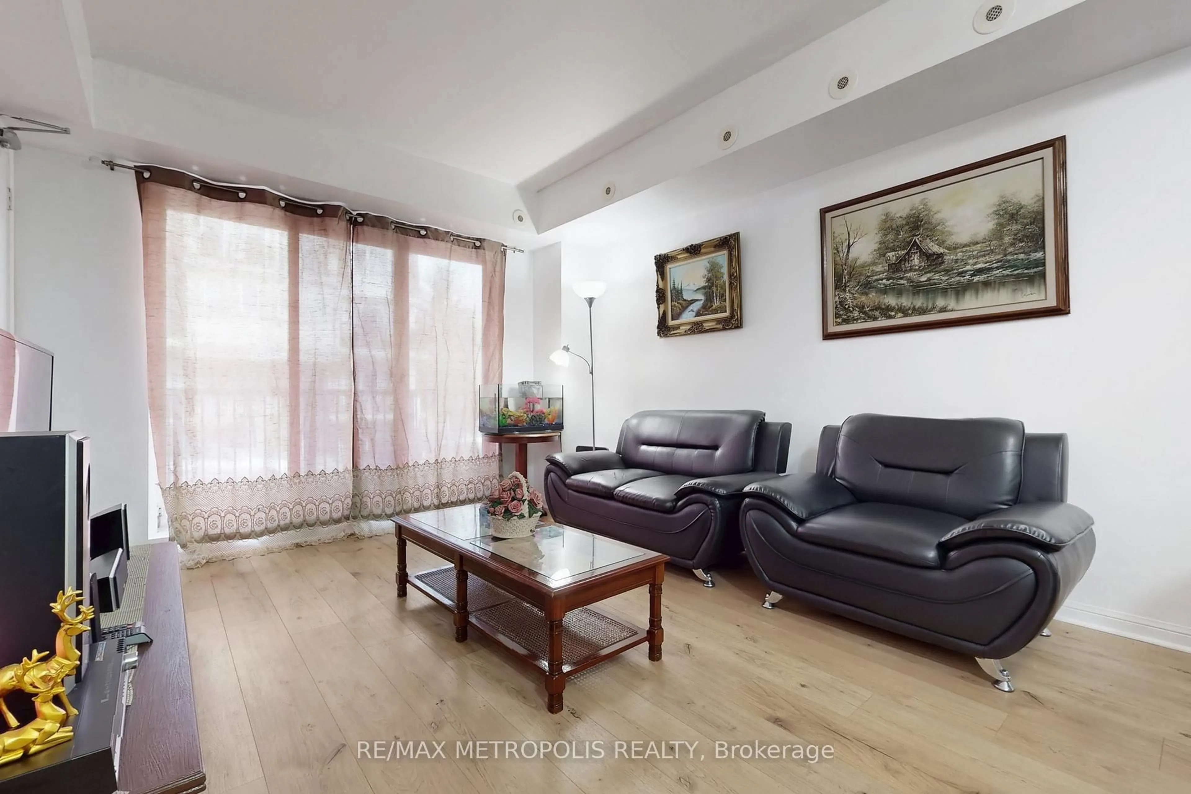 Living room with furniture, wood/laminate floor for 3043 Finch Ave #2025, Toronto Ontario M9M 0A4