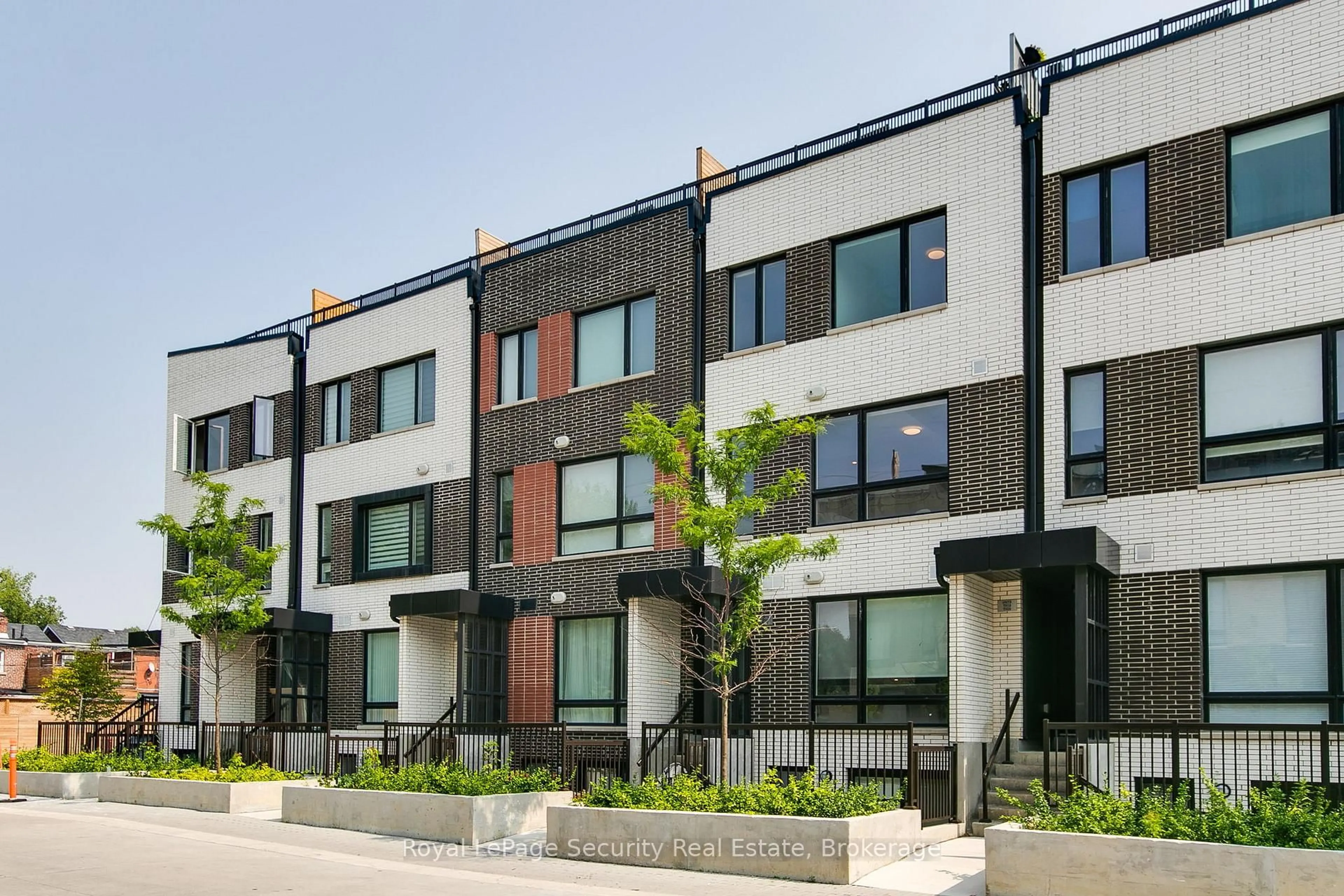 Home with brick exterior material, street for 40 Ed Clark Gdns #TH 22, Toronto Ontario M6N 0B5