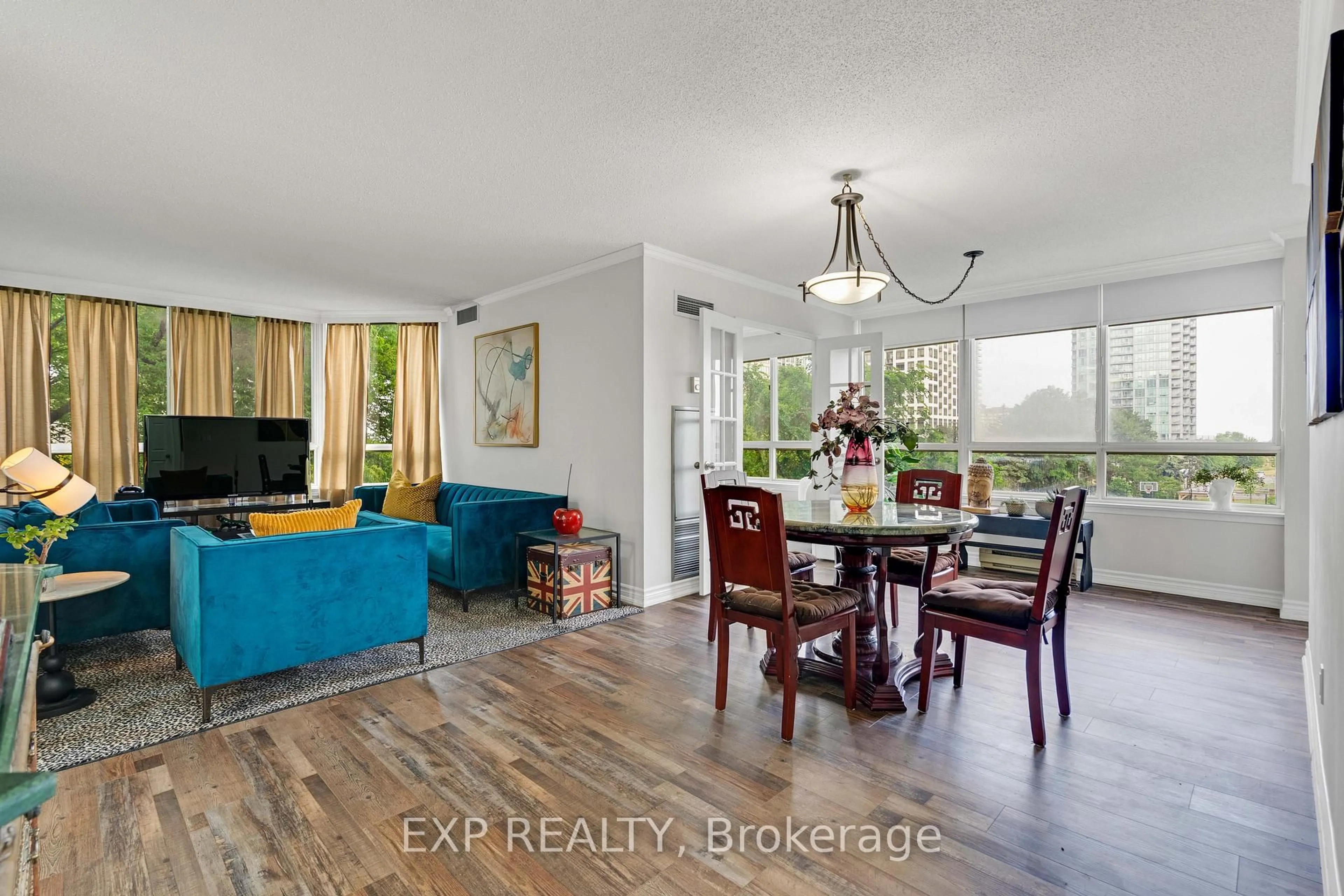 Living room with furniture, wood/laminate floor for 3605 Kariya Dr #203, Mississauga Ontario L5B 3J4