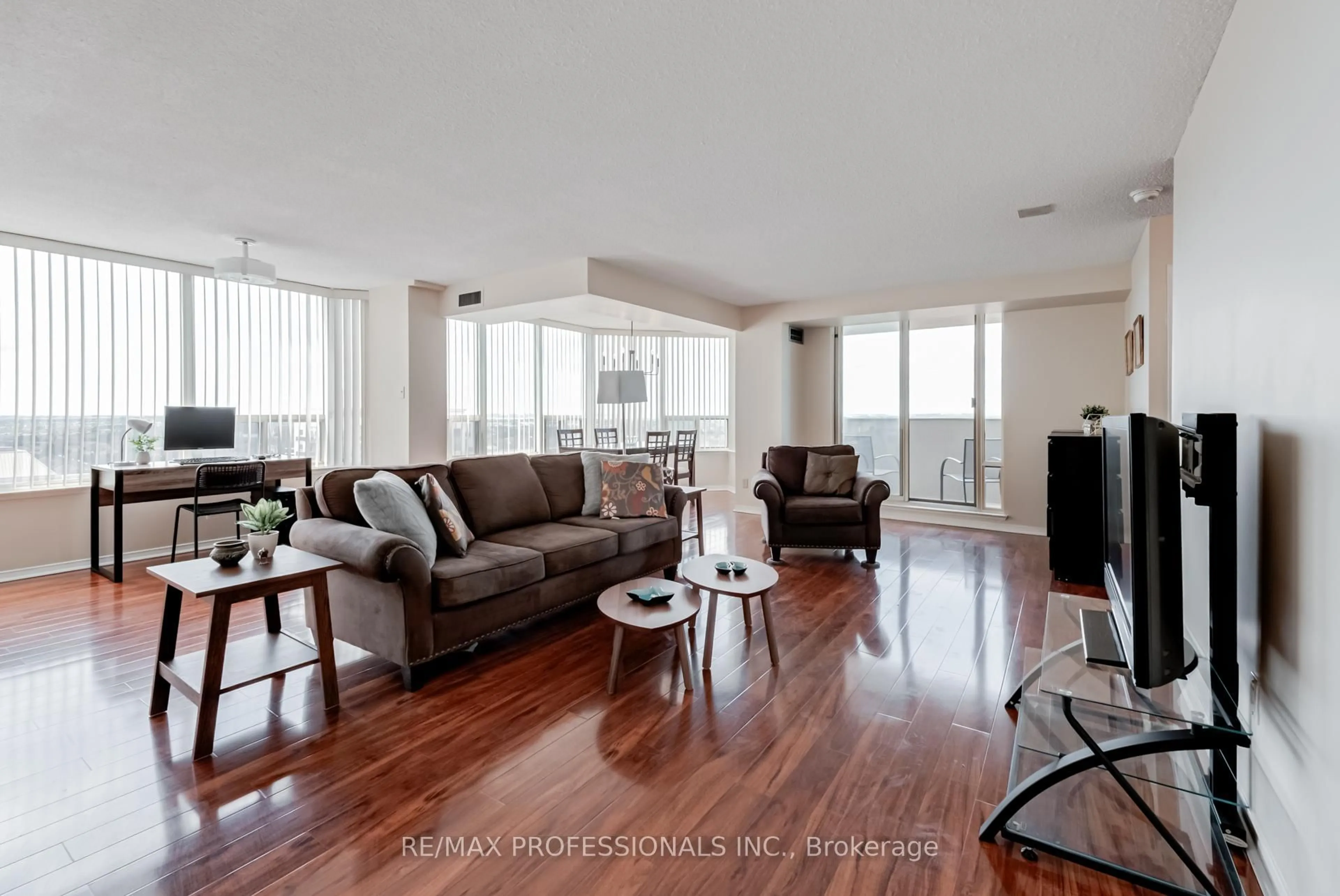 Living room with furniture, wood/laminate floor for 700 Constellation Dr #1703, Mississauga Ontario L5R 3G8