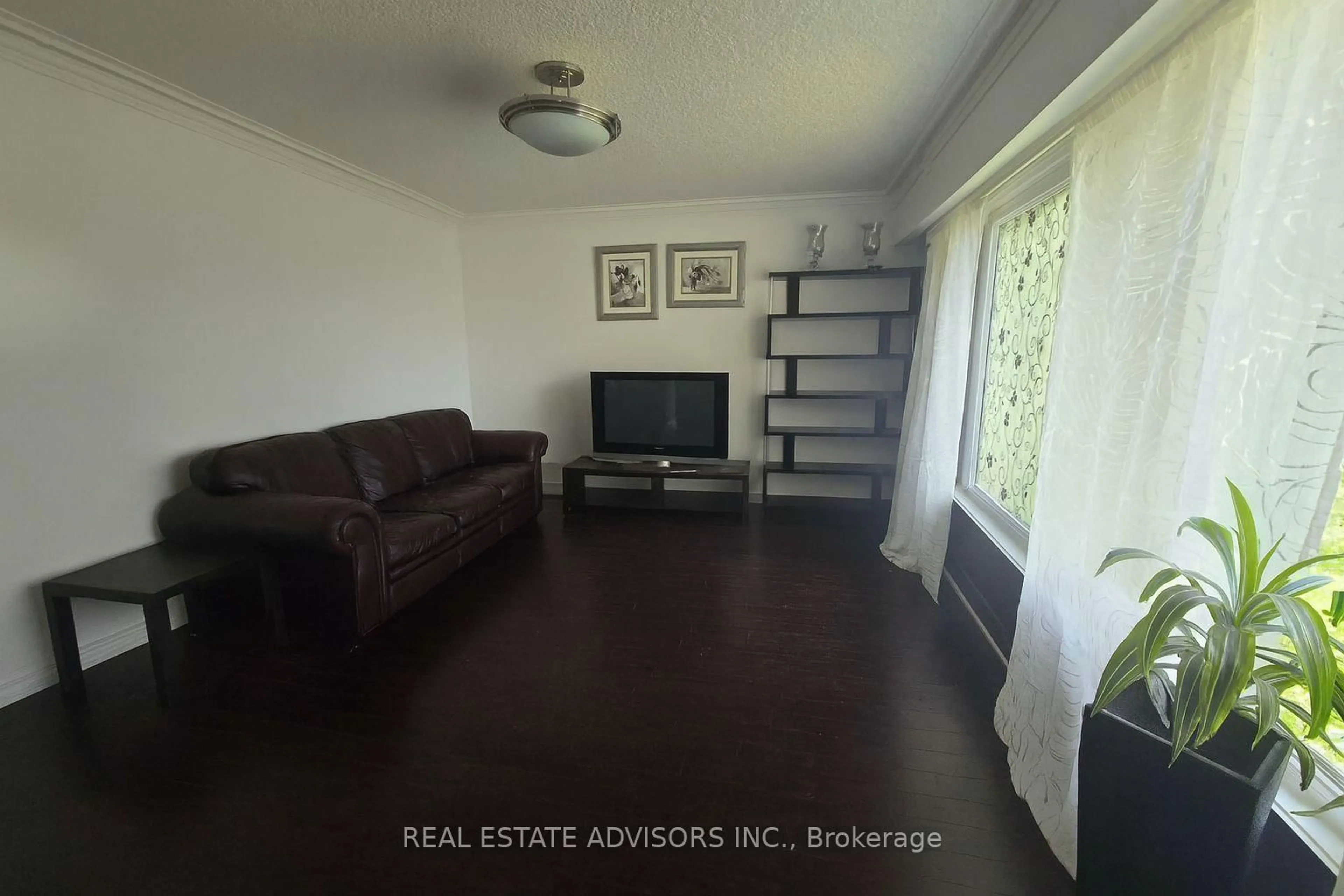 Living room with furniture, wood/laminate floor for 65 Moncrieff Dr, Toronto Ontario M9W 2R3