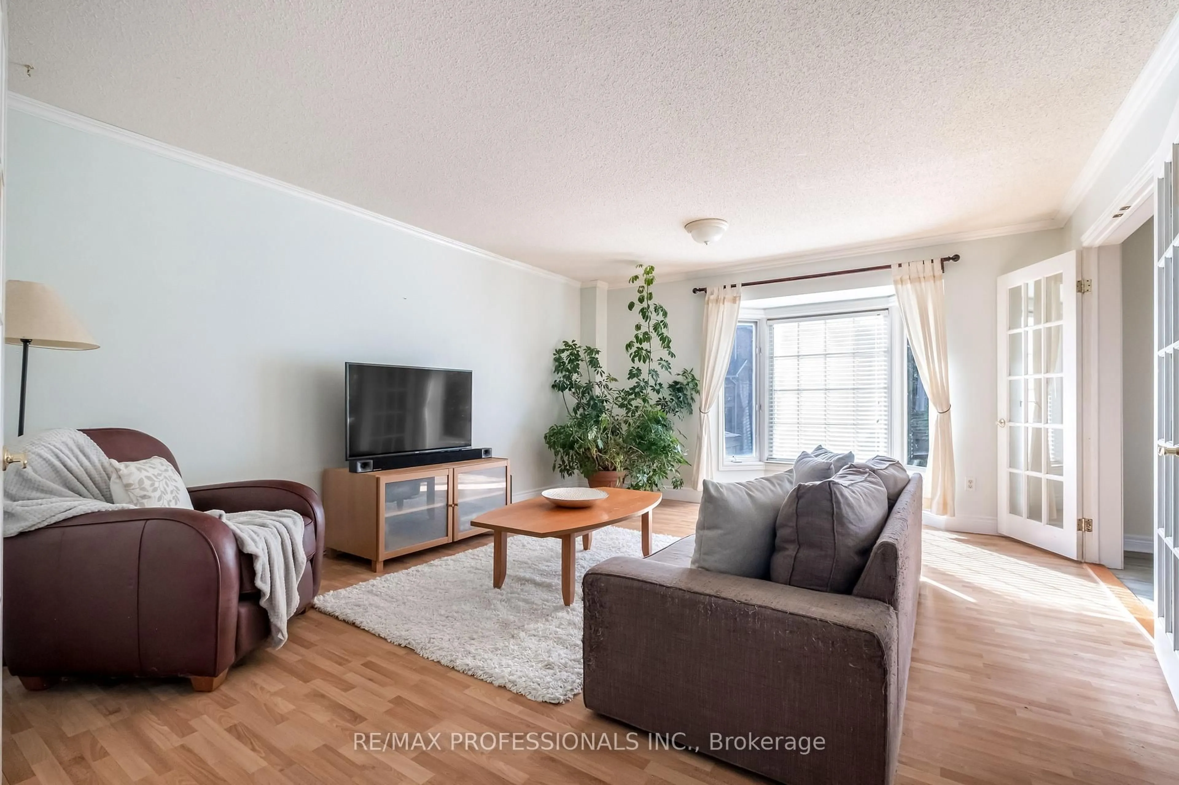 Living room with furniture, wood/laminate floor for 65 Hickorybush Ave, Brampton Ontario L6R 1C8