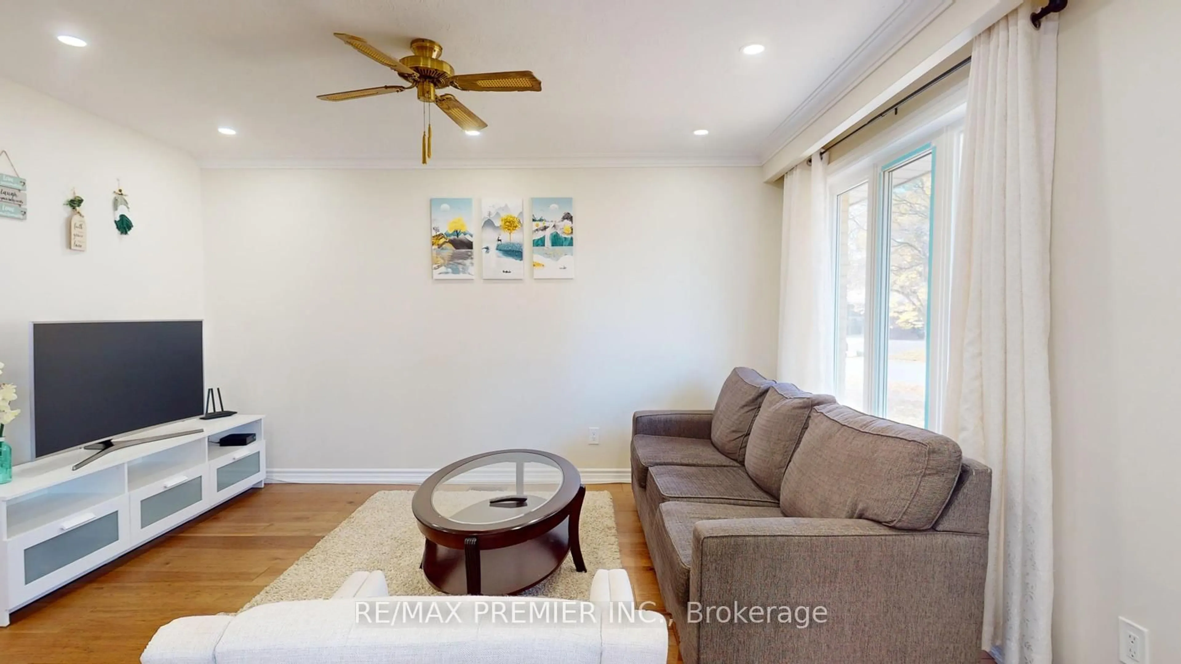 Living room with furniture, wood/laminate floor for 236 Thistle Down Blvd, Toronto Ontario M9V 1K7