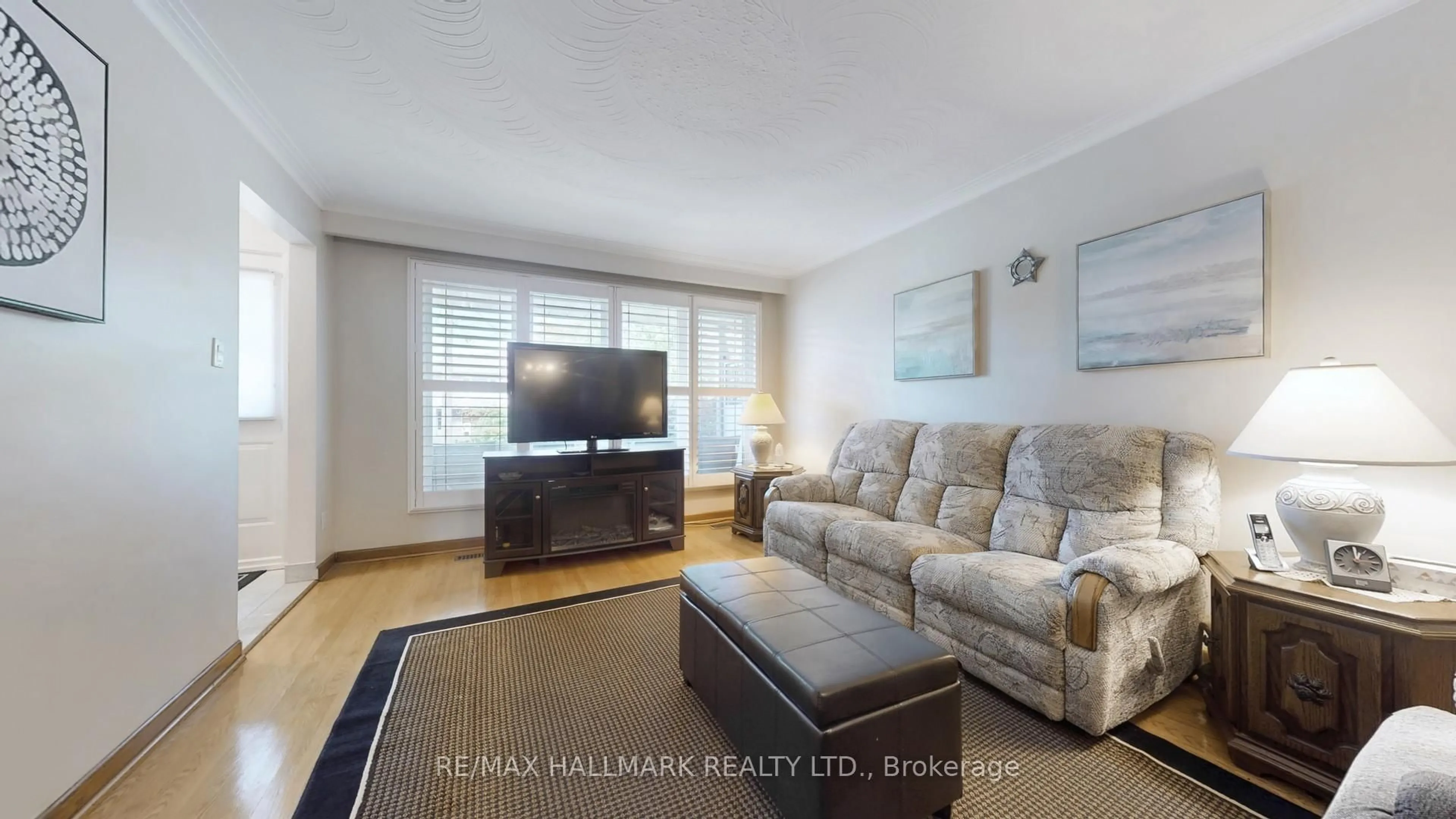 Living room with furniture, wood/laminate floor for 51 Wintergreen Rd, Toronto Ontario M3M 2H9