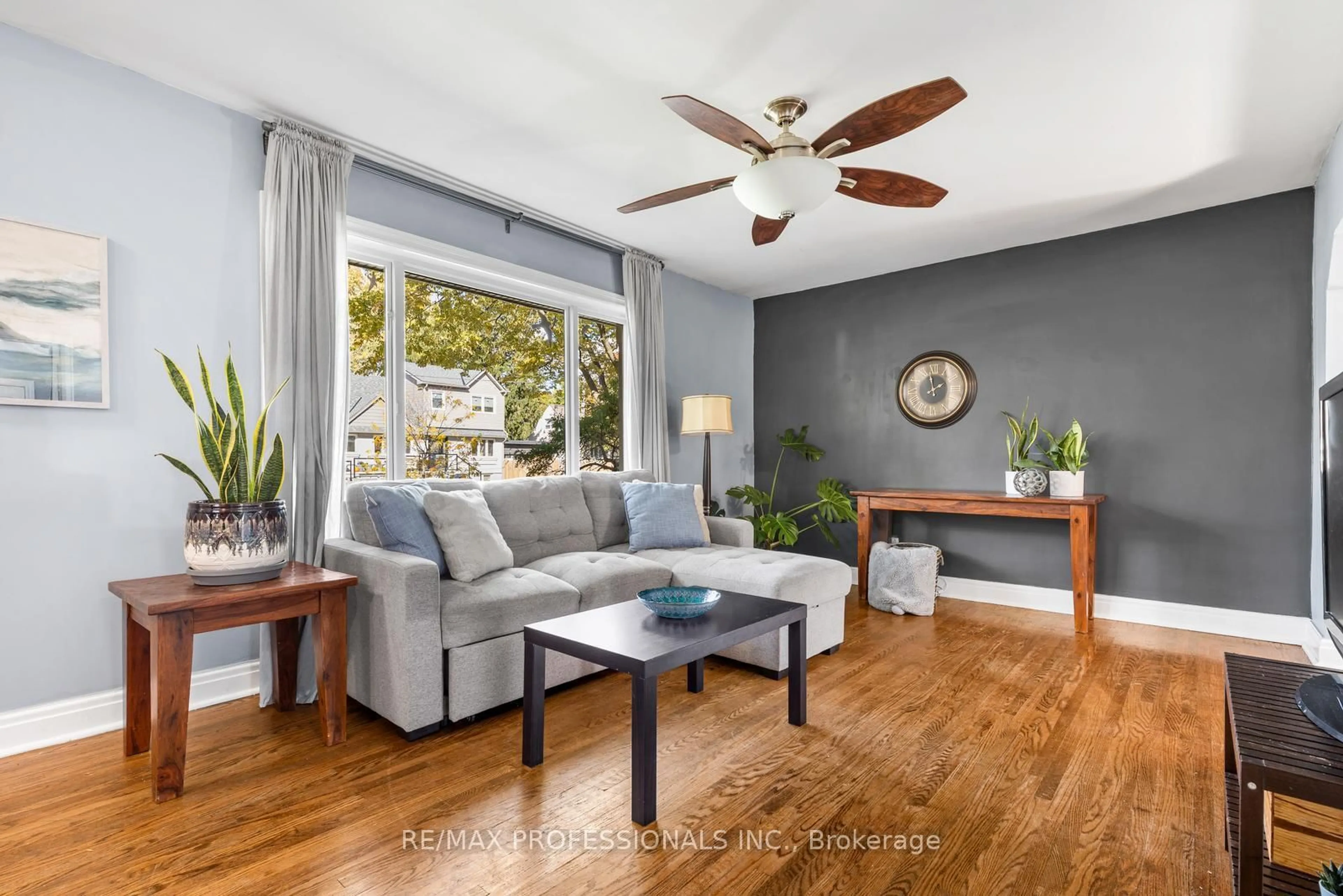 Living room with furniture, wood/laminate floor for 19 Mitcham Dr, Toronto Ontario M8W 2J6