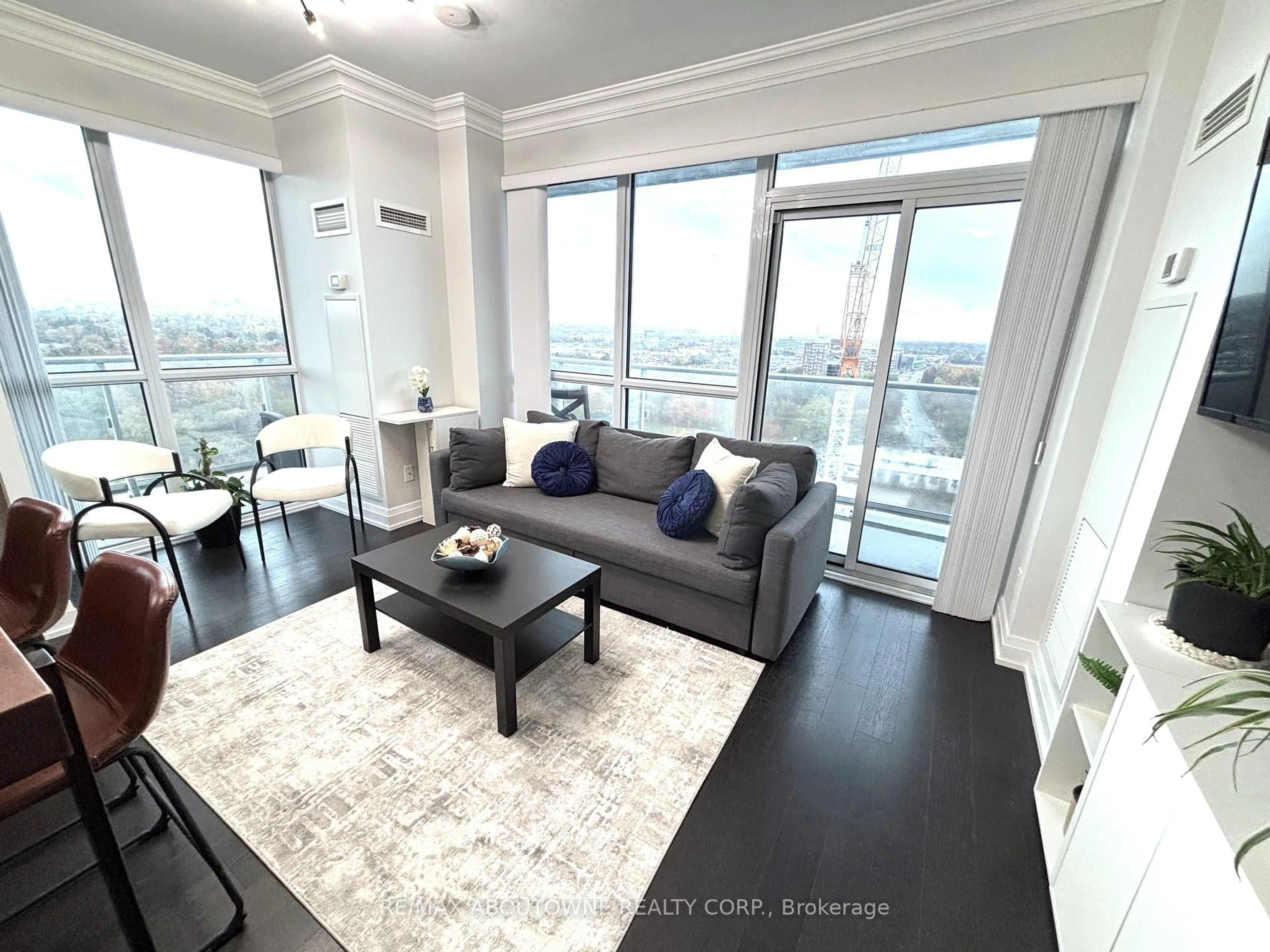 Living room with furniture, wood/laminate floor for 65 Speers Rd #1503, Oakville Ontario L6K 0J1