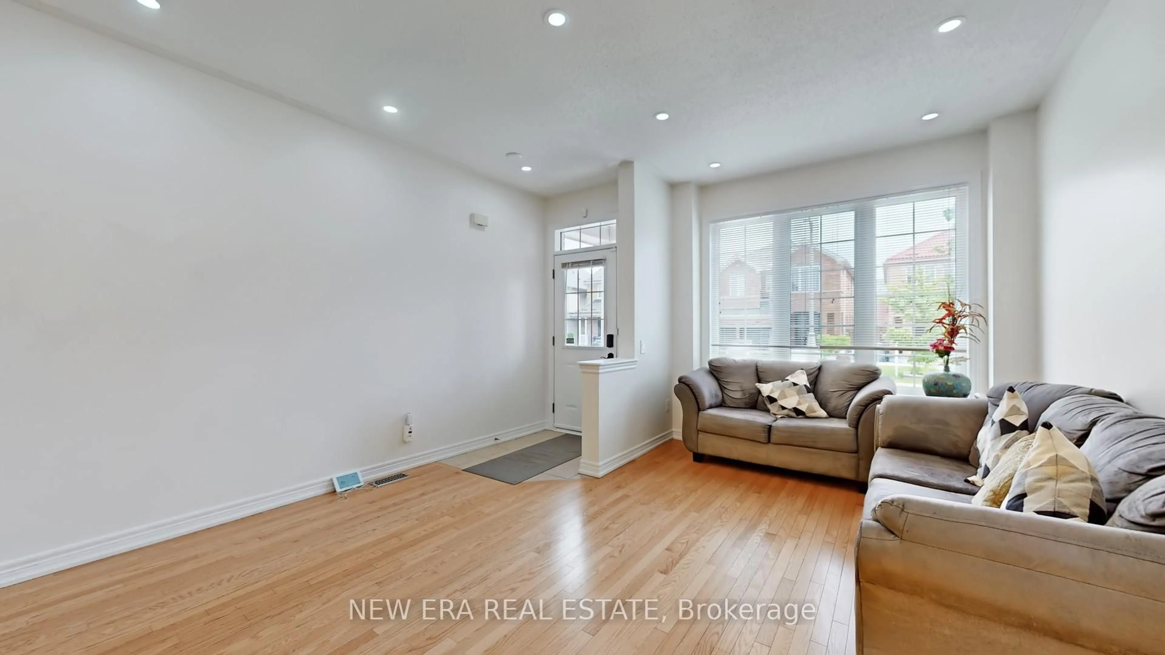 Living room with furniture, wood/laminate floor for 26 Openbay Gdns, Brampton Ontario L6R 0V4