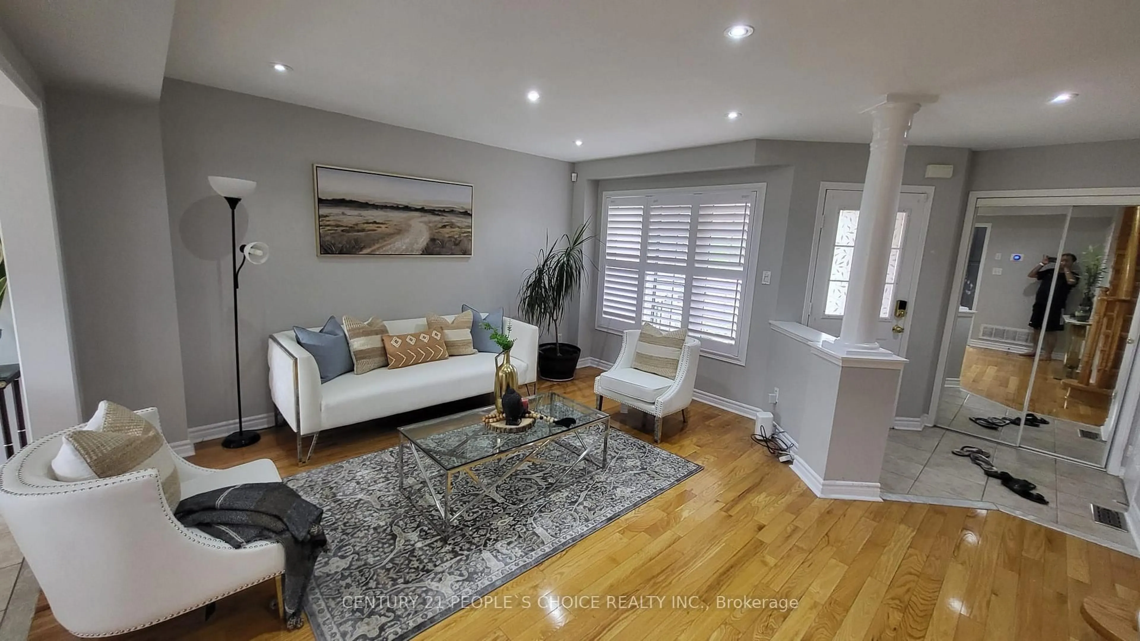 Living room with furniture, wood/laminate floor for 7598 Black Walnut Tr, Mississauga Ontario L5N 8A7
