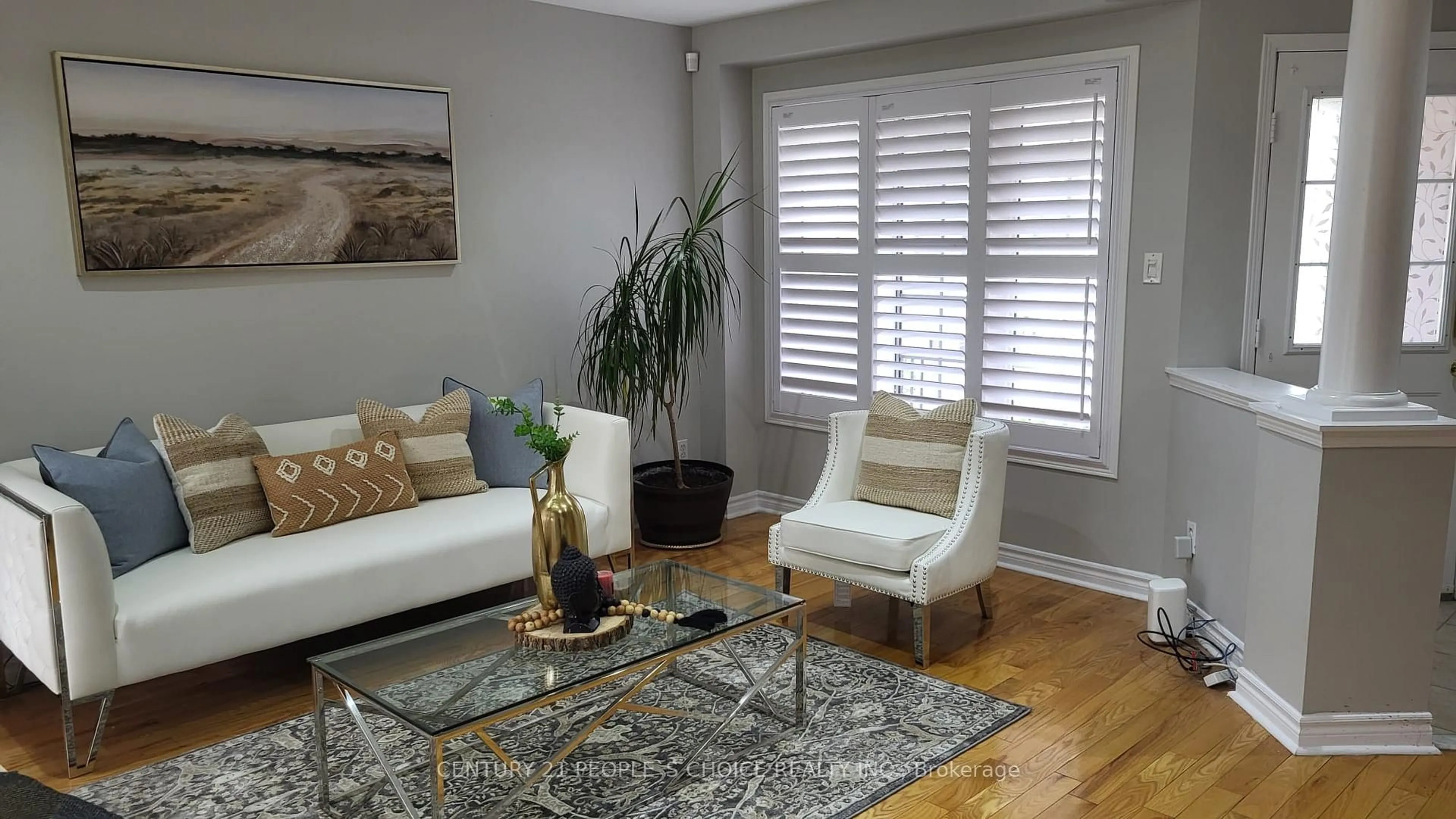 Living room with furniture, wood/laminate floor for 7598 Black Walnut Tr, Mississauga Ontario L5N 8A7