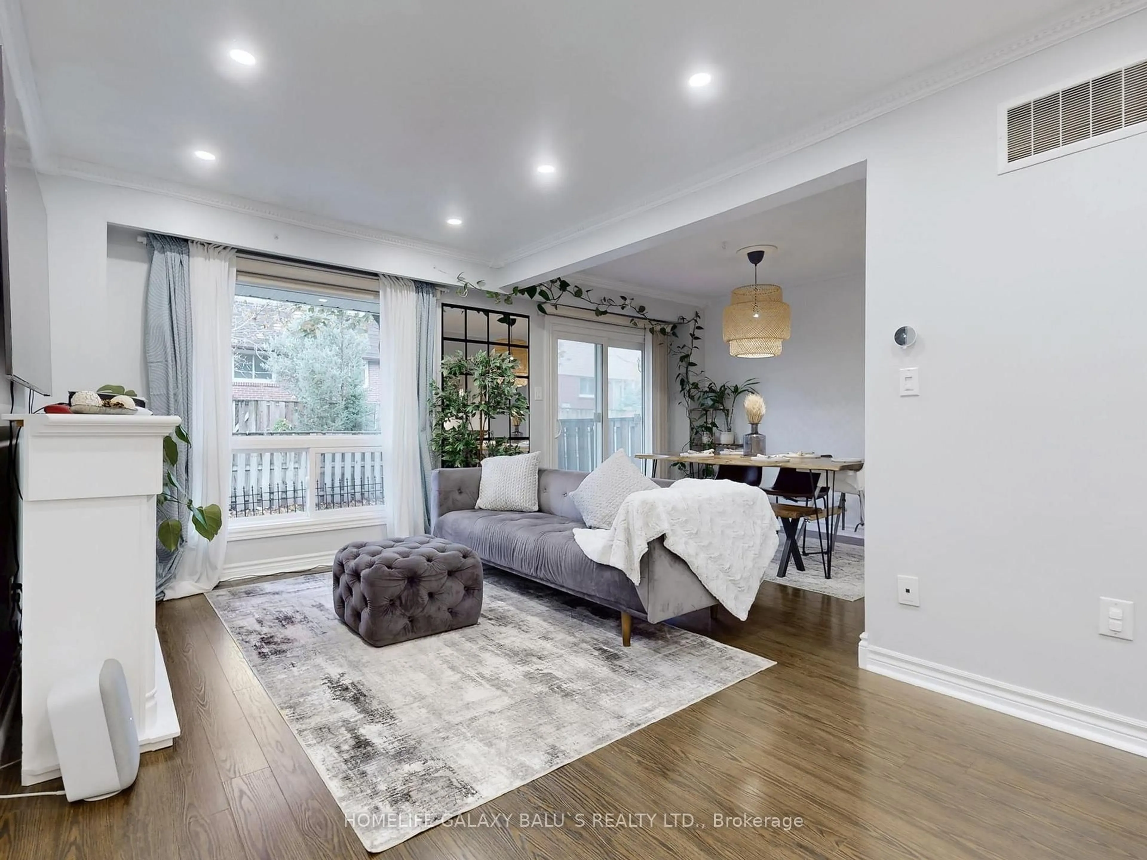 Living room with furniture, wood/laminate floor for 830 Stainton Dr #65, Mississauga Ontario L5C 2Z3