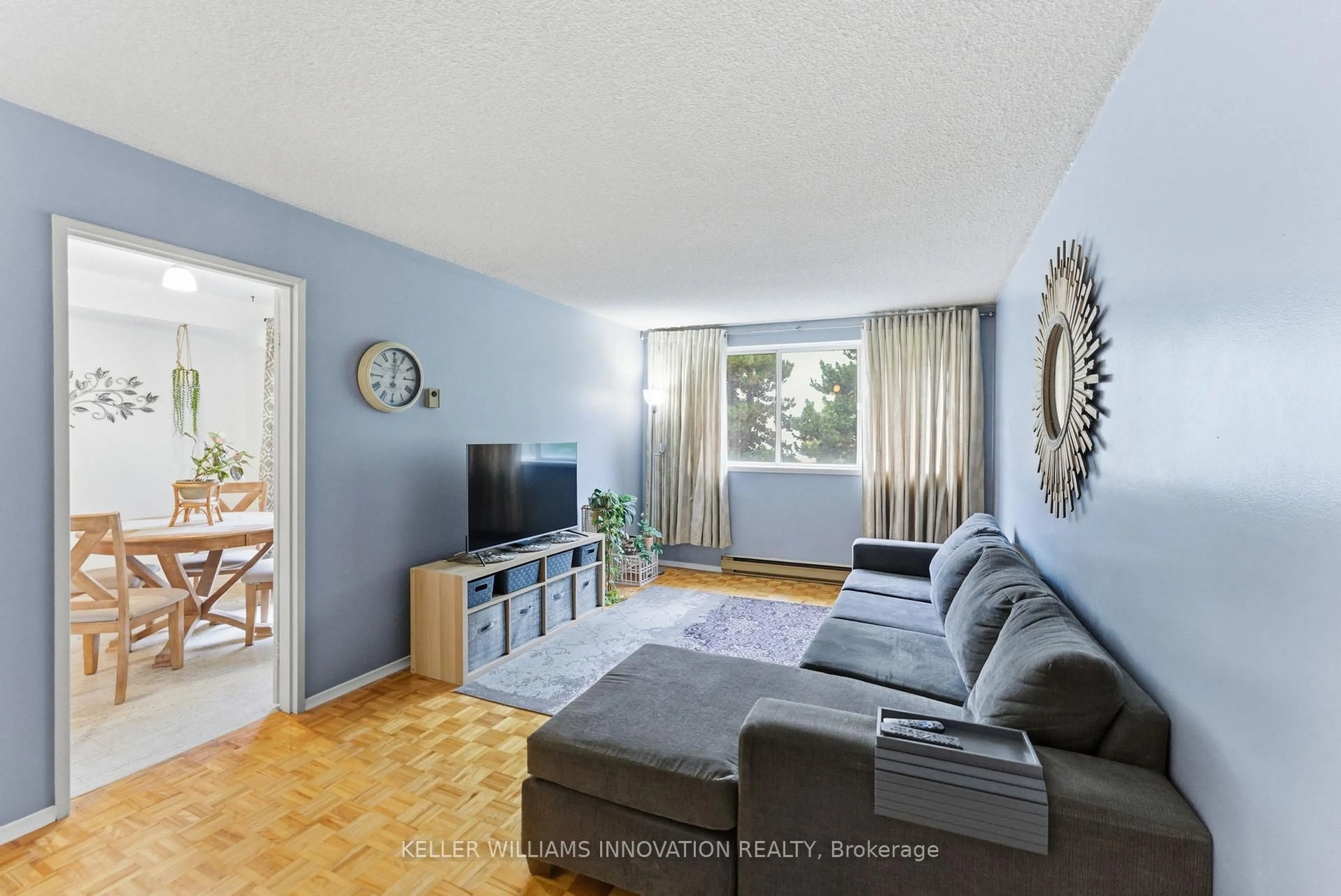 Living room with furniture, wood/laminate floor for 2170 Bromsgrove Rd #175, Mississauga Ontario L5J 4J2