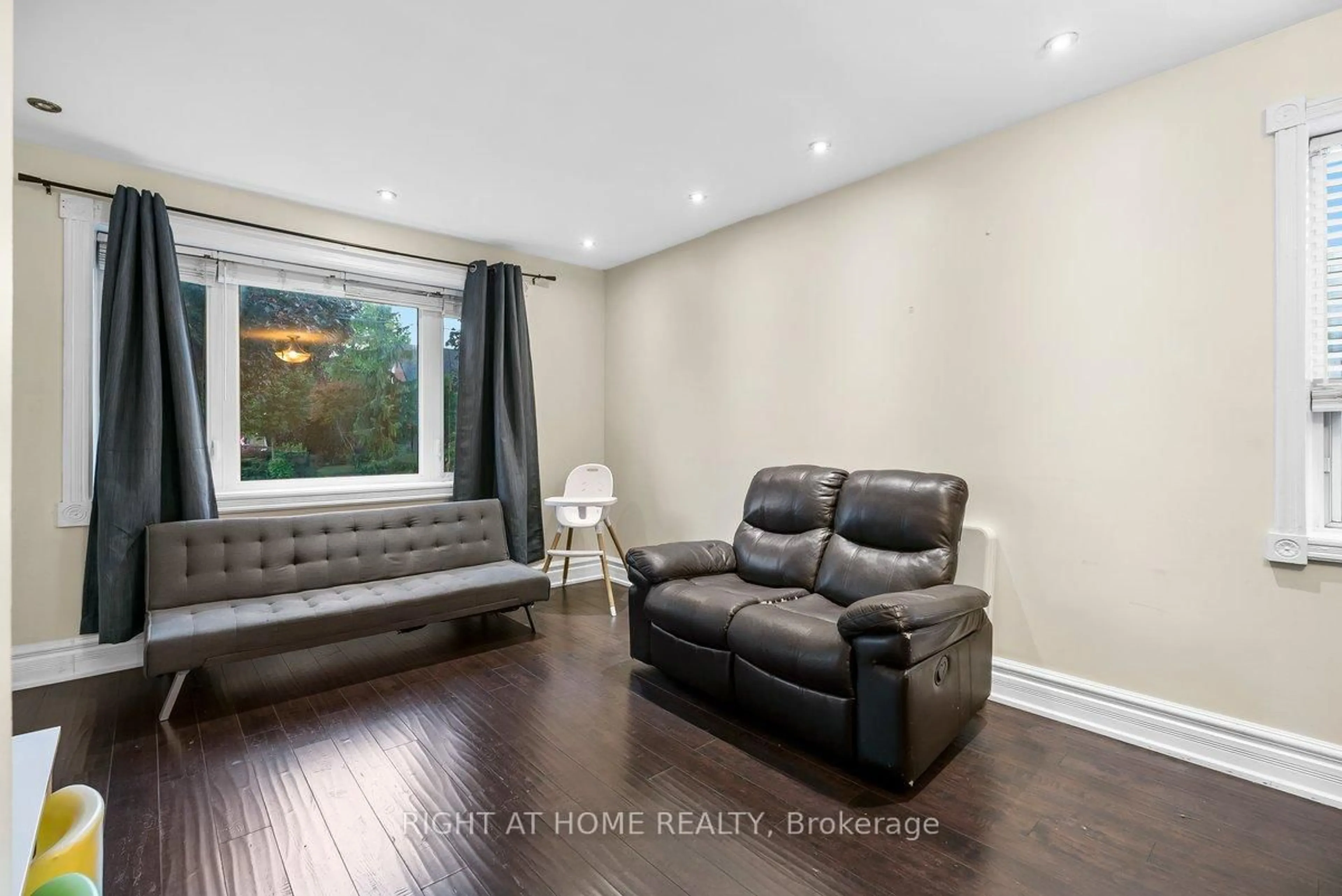 Living room with furniture, wood/laminate floor for 6 Melody Rd, Toronto Ontario M9M 1C7
