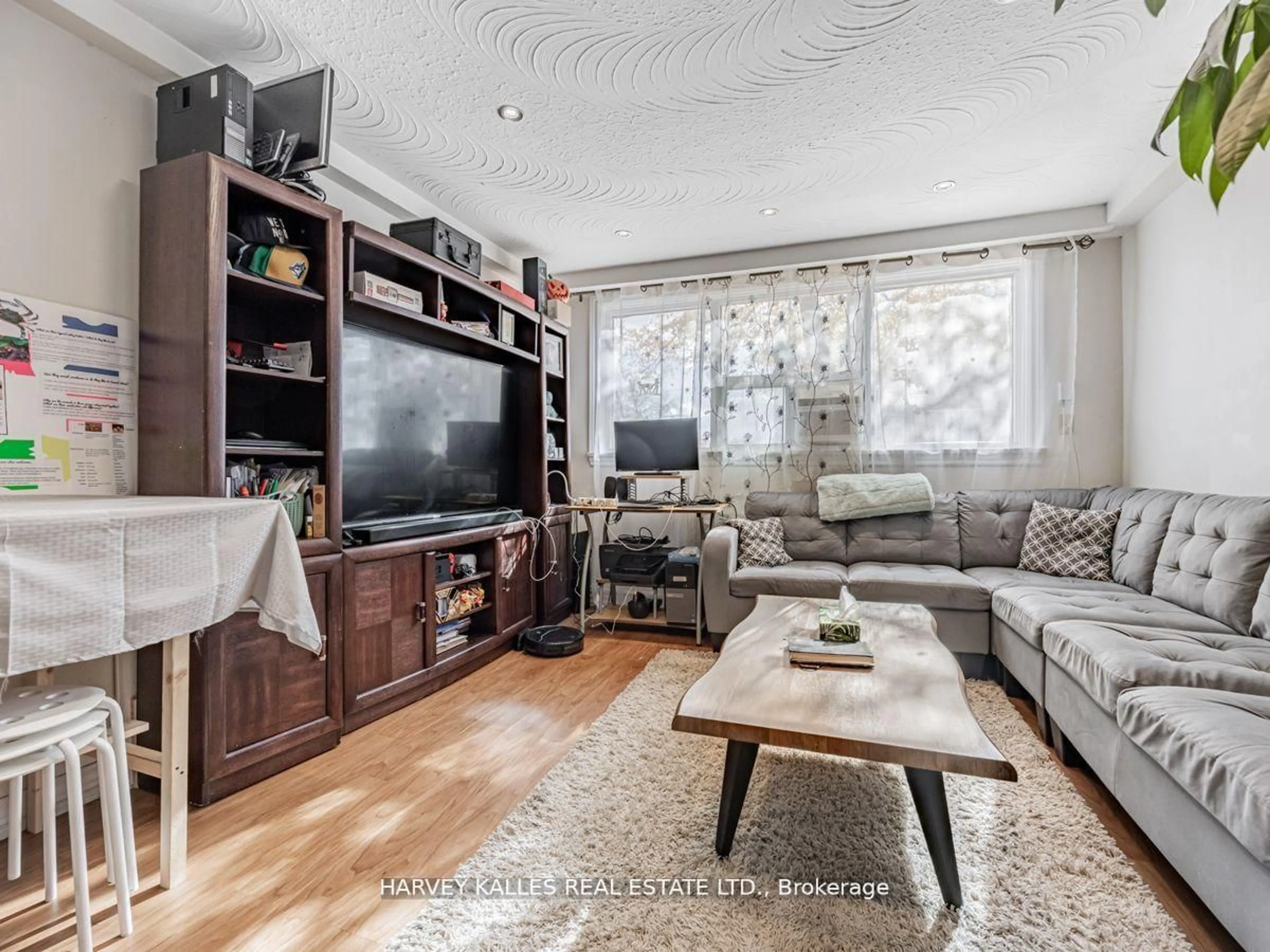 Living room with furniture, wood/laminate floor for 6 Carrington Ave, Toronto Ontario M6E 2C3