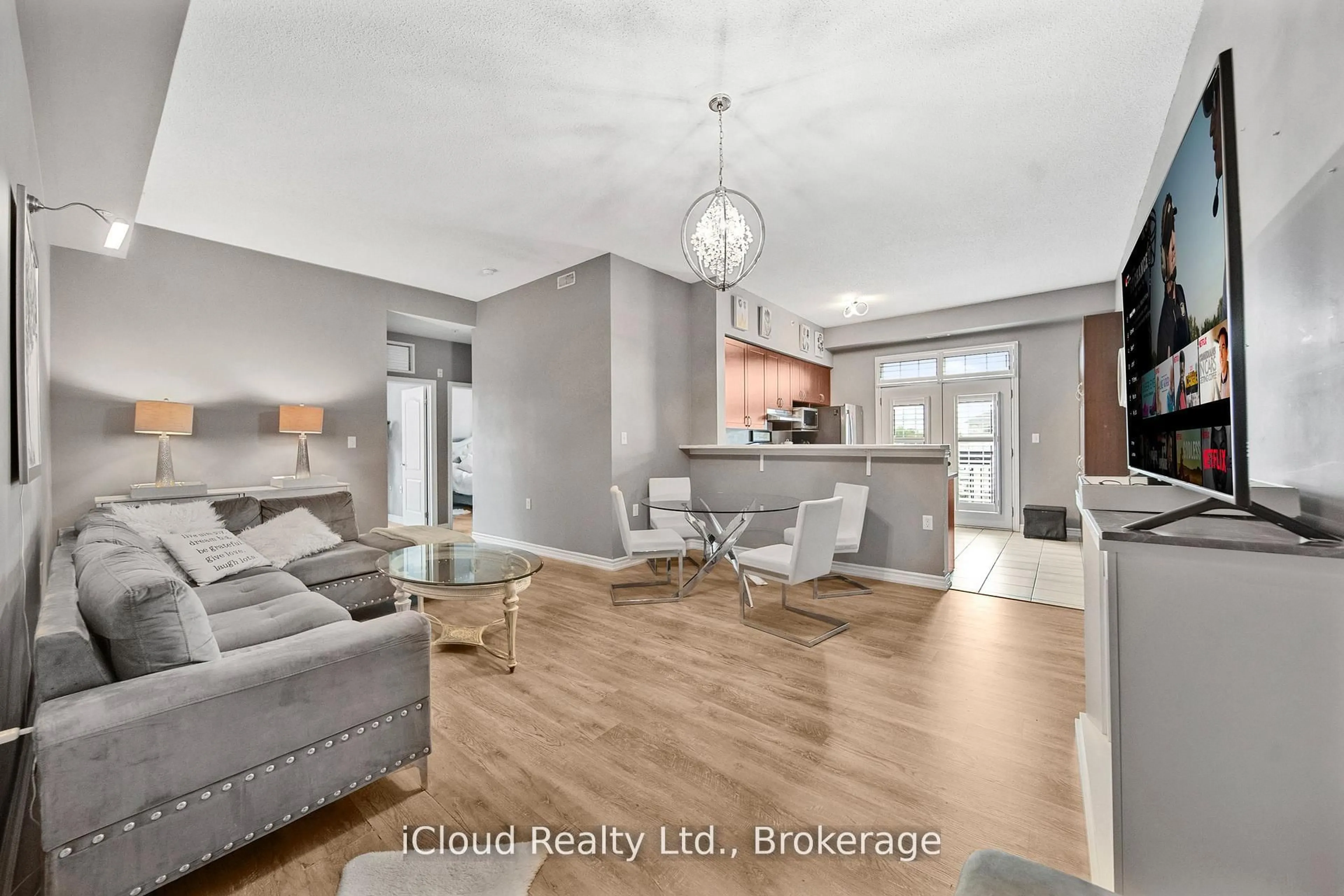 Living room with furniture, wood/laminate floor for 1440 Main St #411, Milton Ontario L9T 8W3