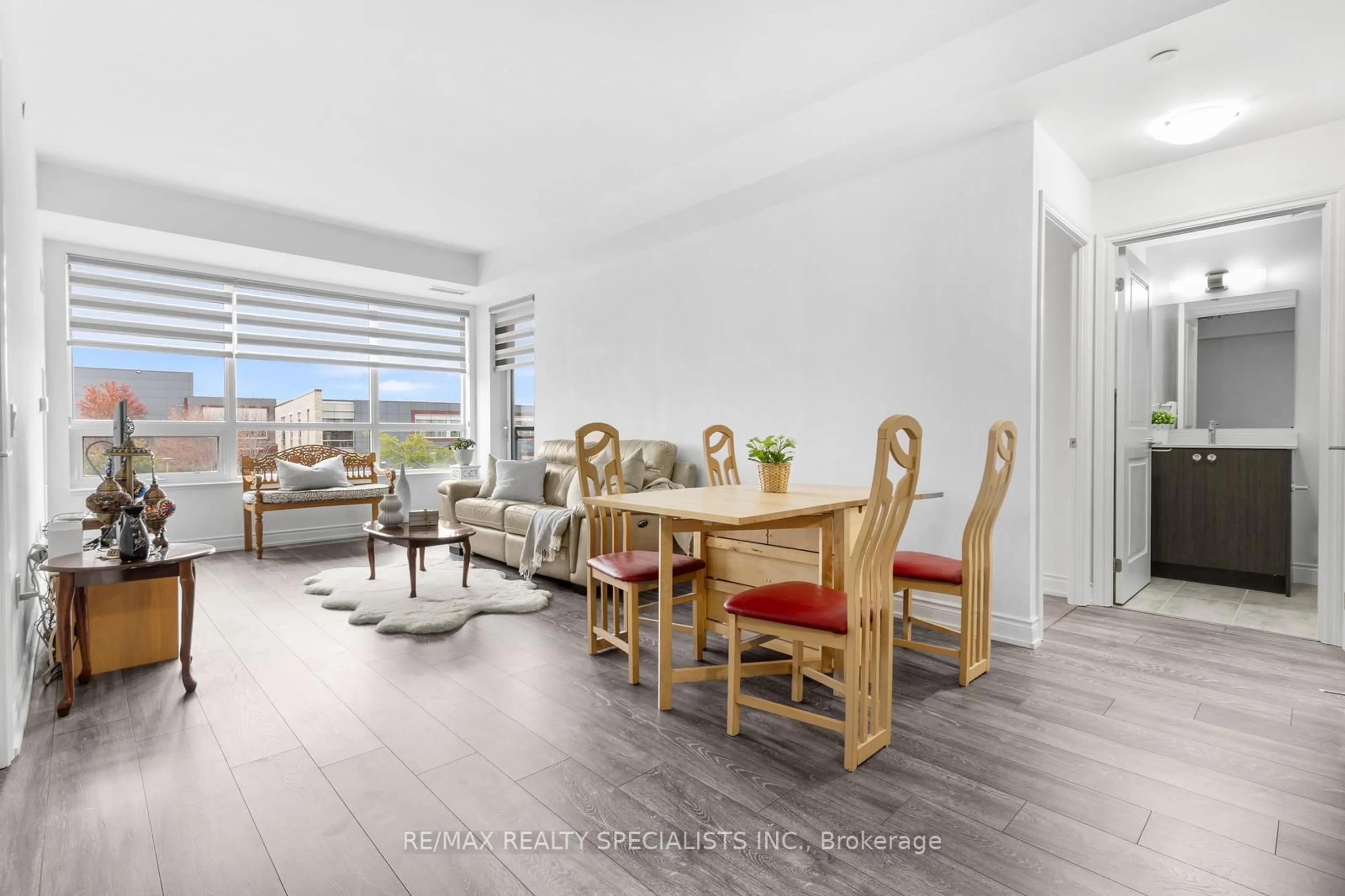 Living room with furniture, wood/laminate floor for 1050 Main St #226, Milton Ontario L9T 9M3