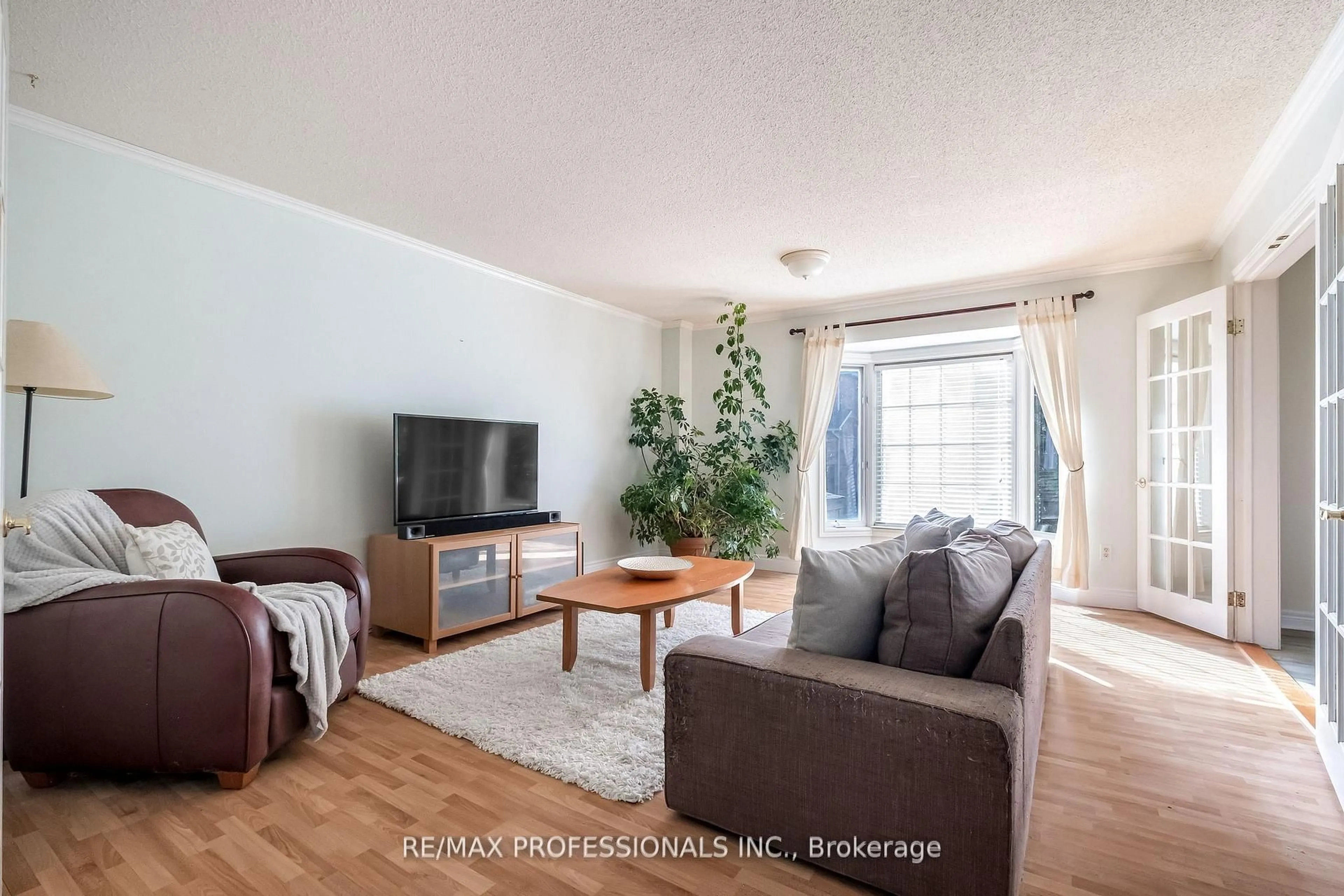 Living room with furniture, wood/laminate floor for 65 Hickorybush Ave, Brampton Ontario L6R 1C8