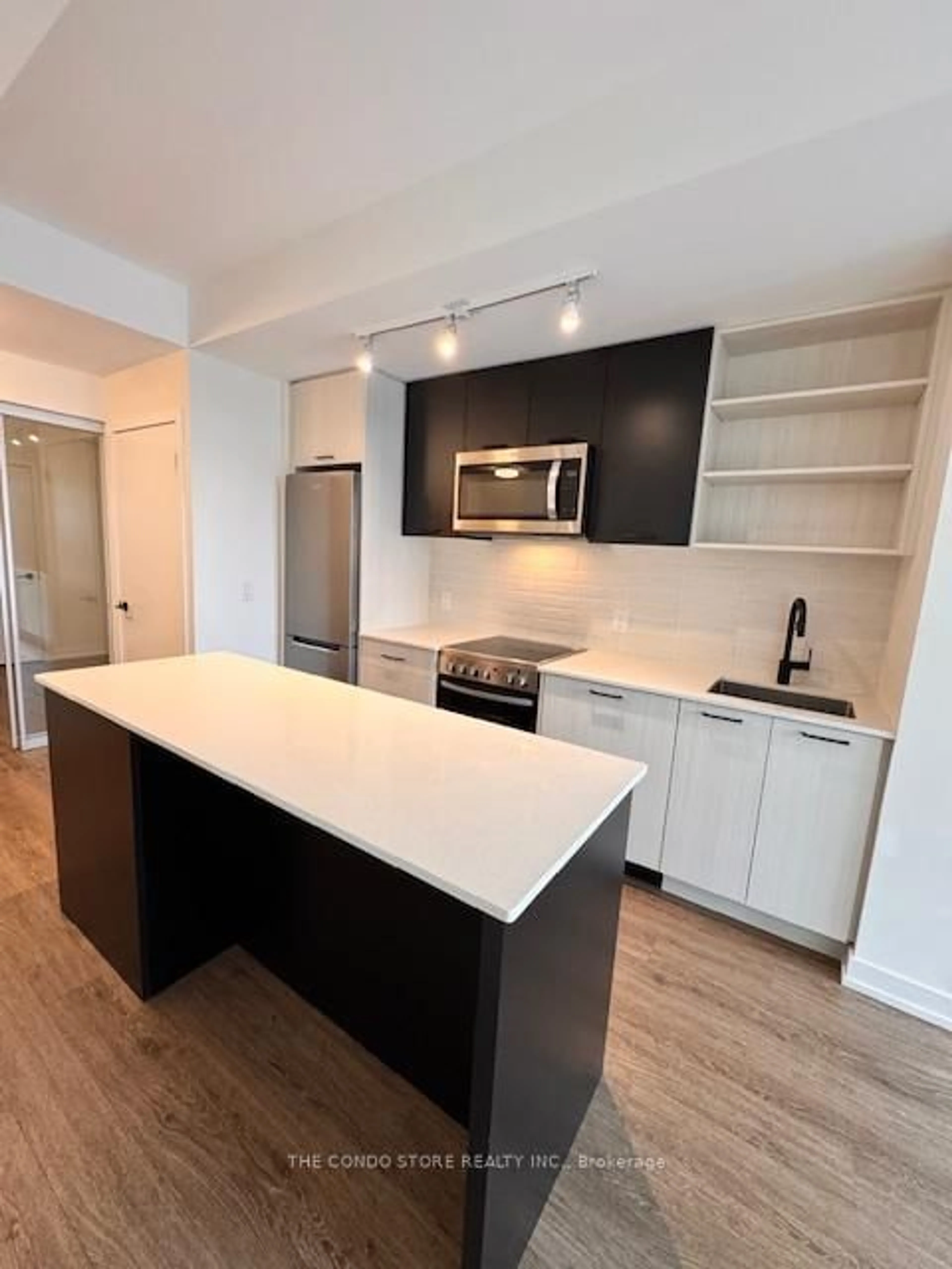 Open concept kitchen, wood/laminate floor for 2300 St. Clair Ave #702, Toronto Ontario M6N 0B3