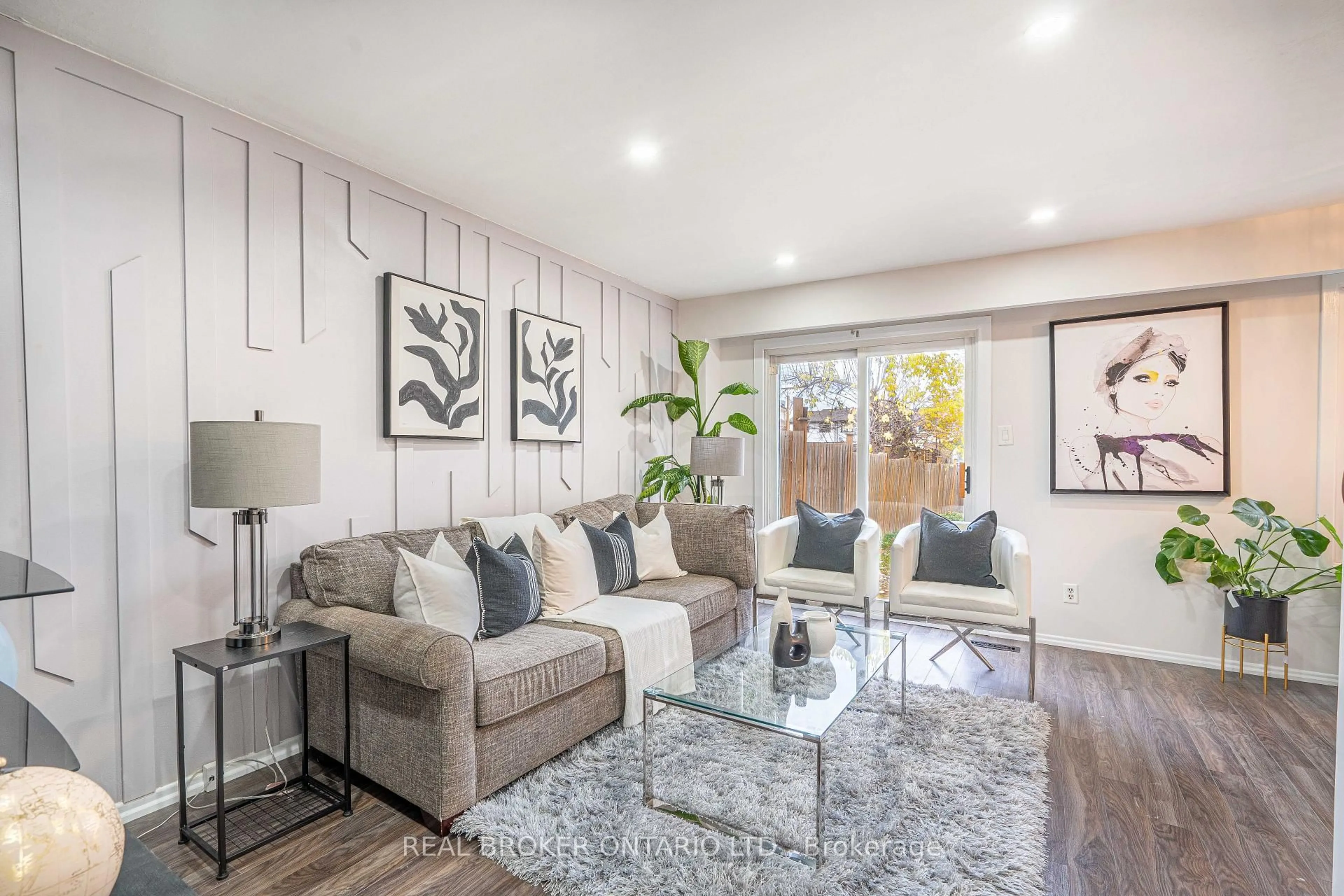 Living room with furniture, wood/laminate floor for 27 Kingswood Dr, Brampton Ontario L6V 2X5