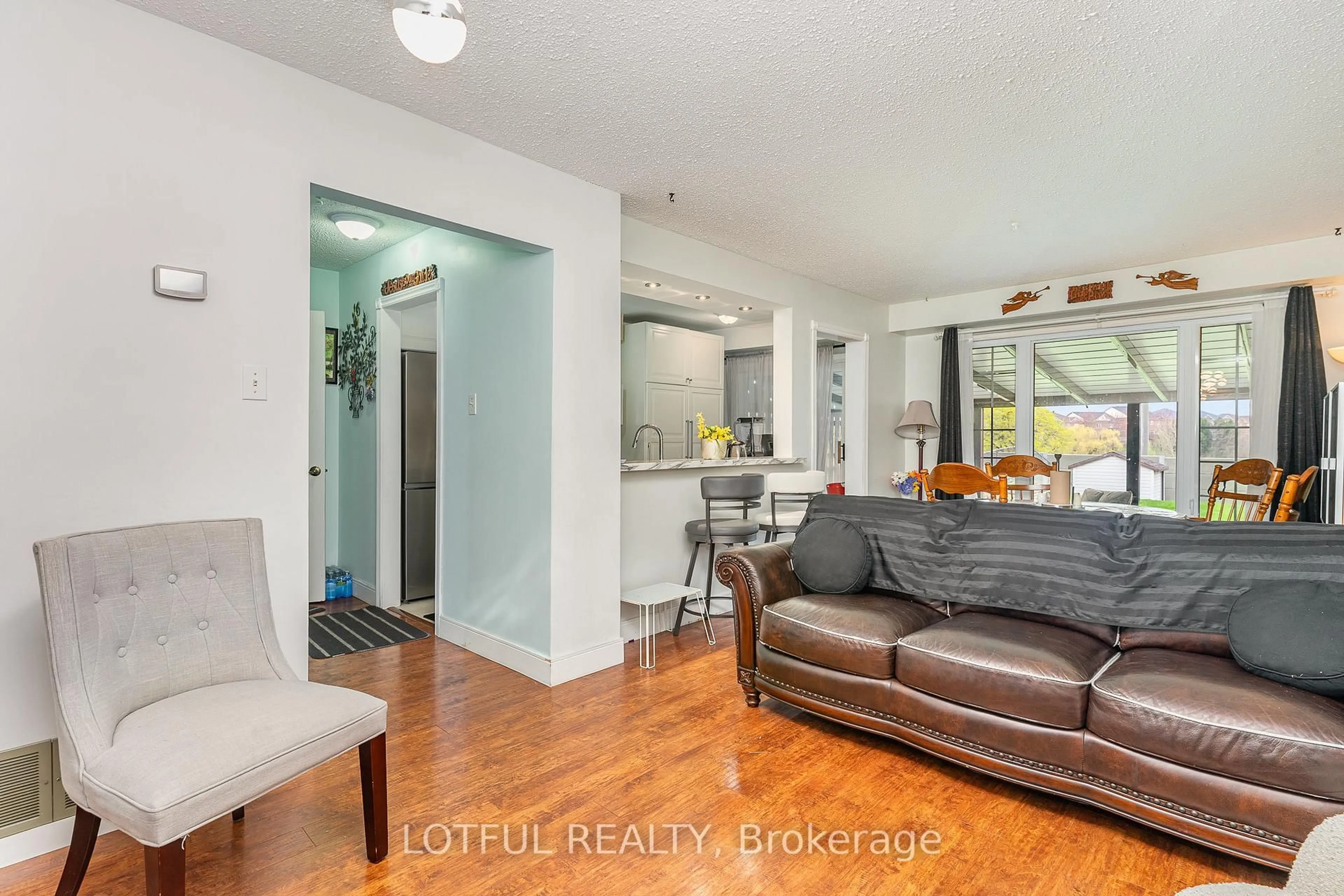 Living room with furniture, wood/laminate floor for 134 Royal Salisbury Way, Brampton Ontario L6V 3J8