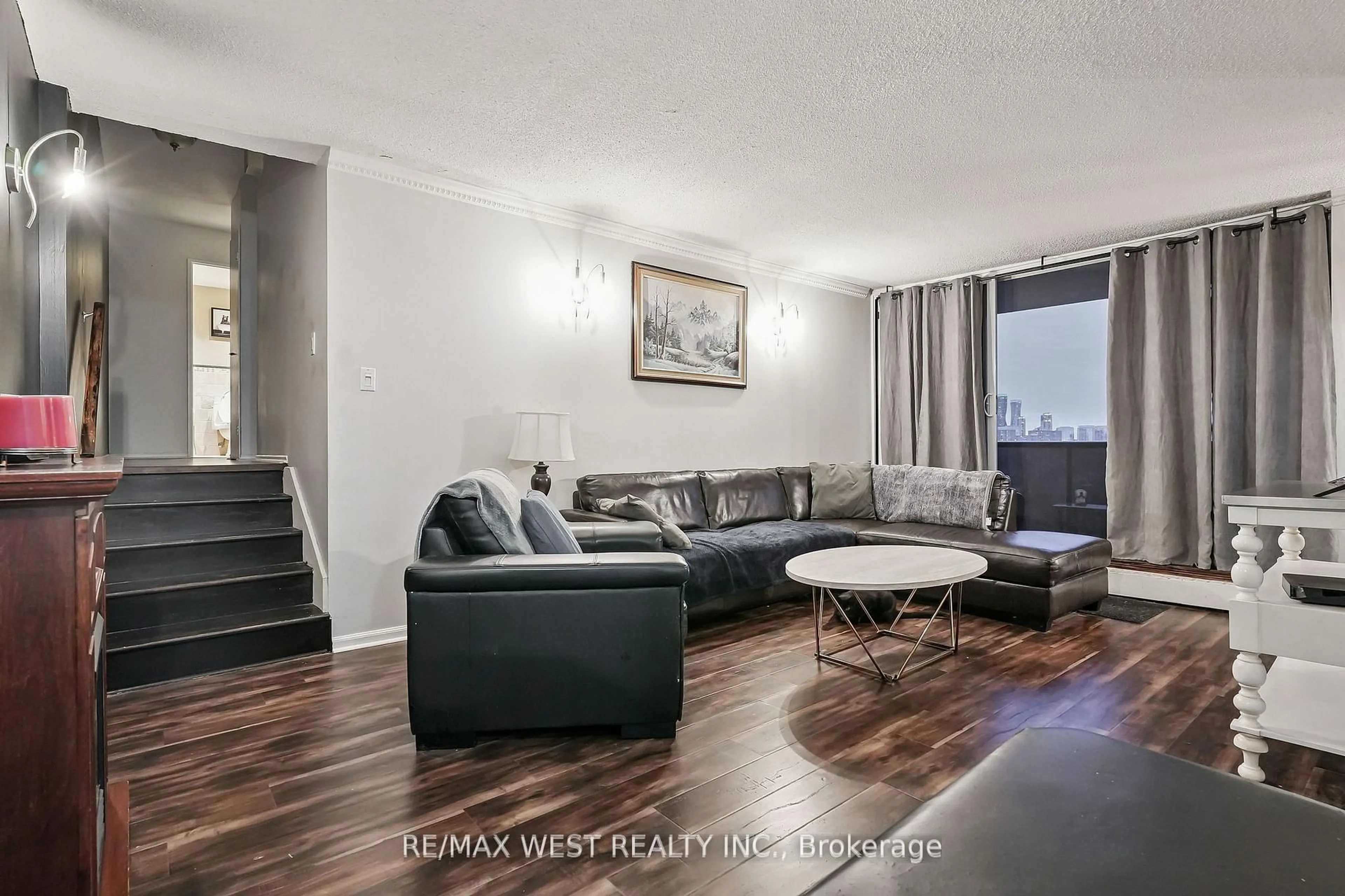 Living room with furniture, wood/laminate floor for 530 Lolita Gdns #1203, Mississauga Ontario L5A 3T2