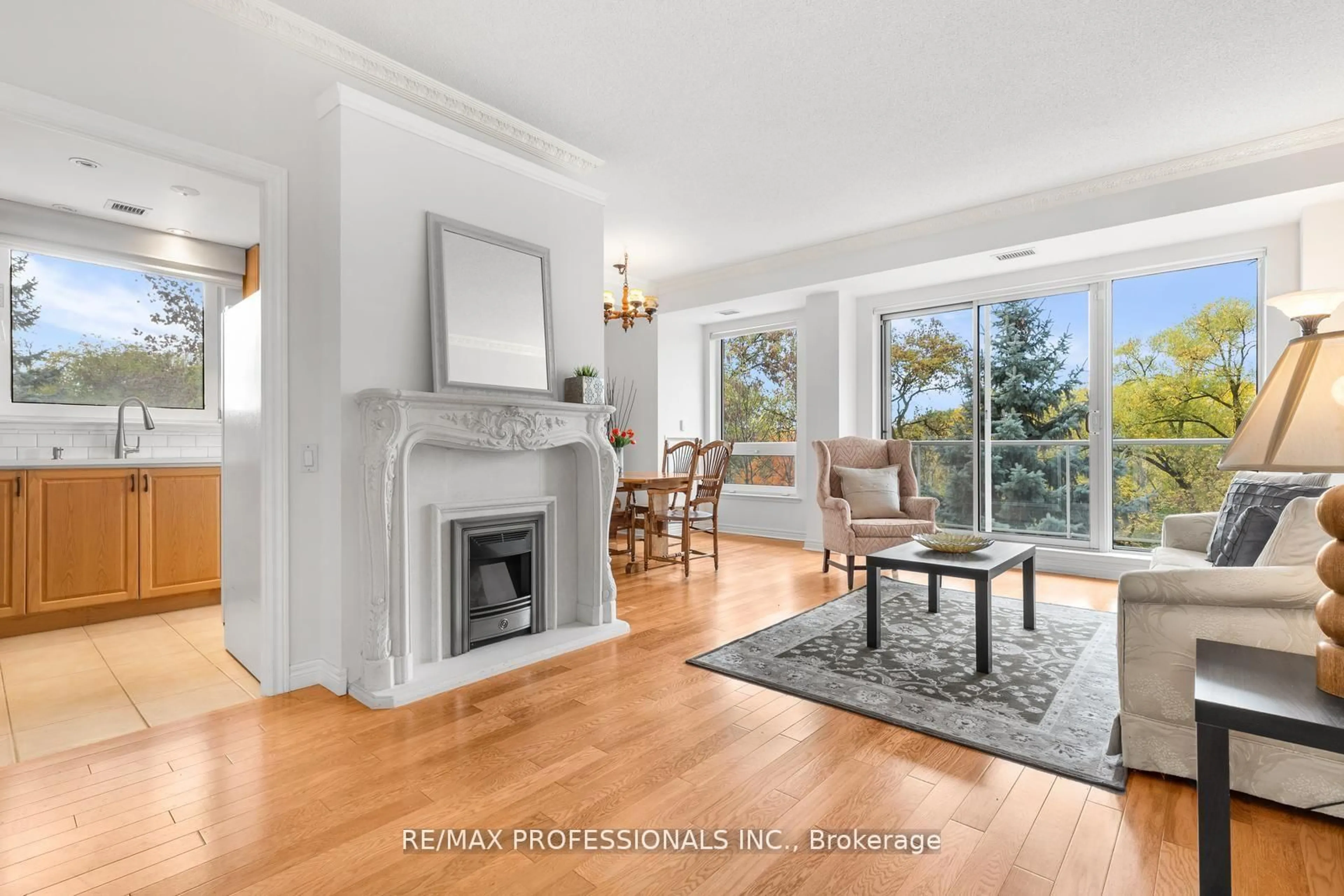 Living room with furniture, wood/laminate floor for 350 Mill Rd #211, Toronto Ontario M9C 5R7