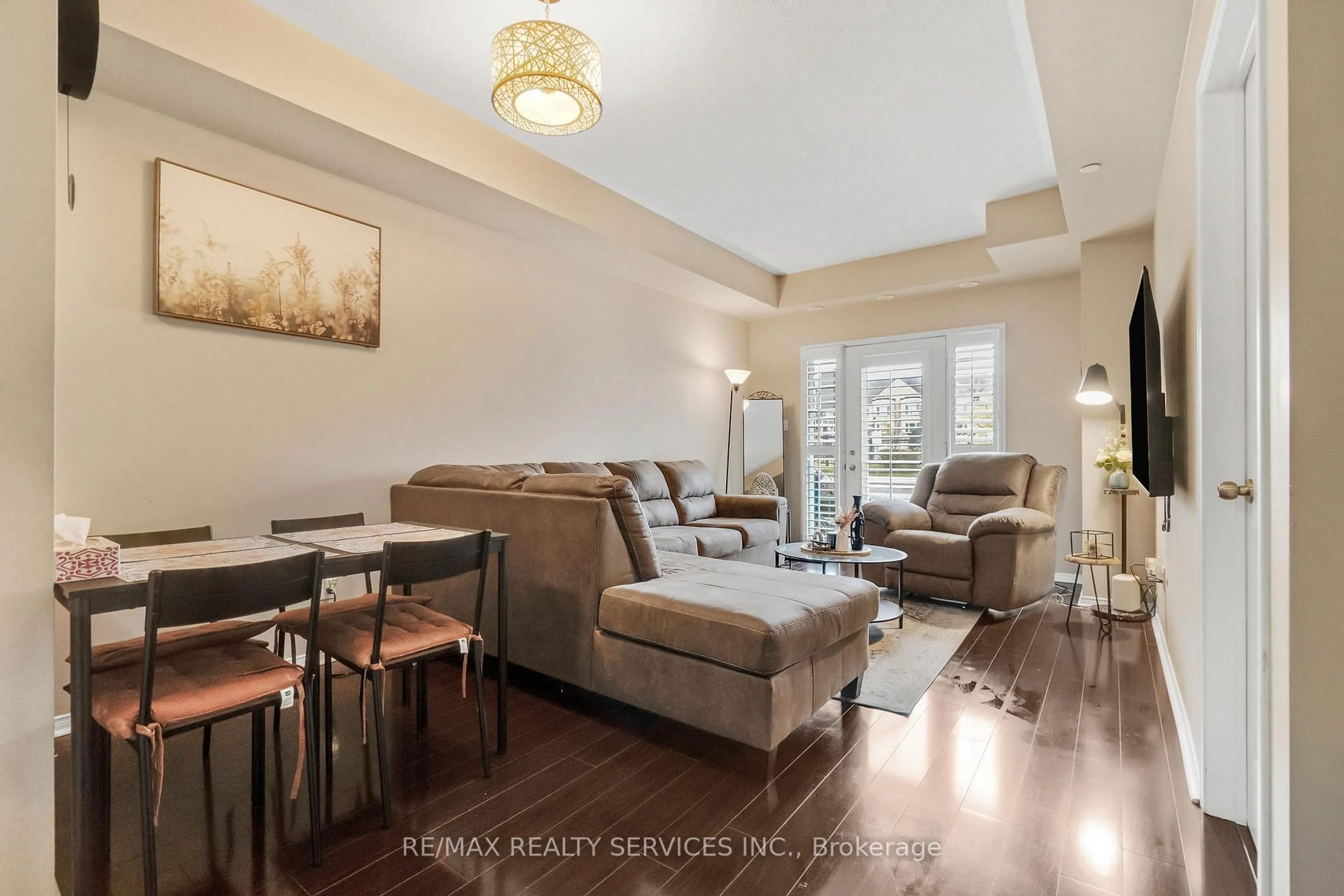 Living room with furniture, wood/laminate floor for 5150 Winston Churchill Blvd #101, Mississauga Ontario L5M 0P1