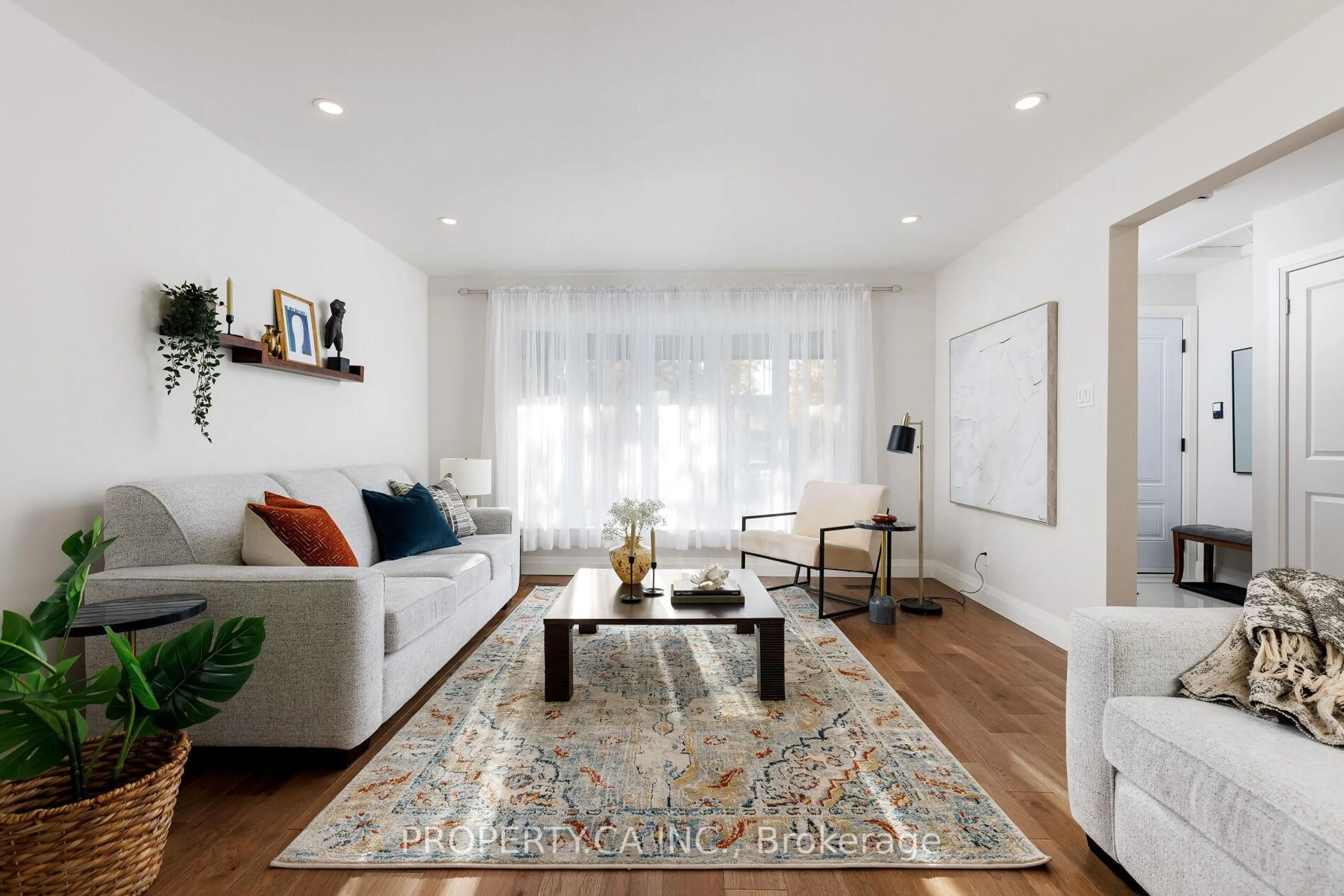 Living room with furniture, wood/laminate floor for 132 Princess Anne Cres, Toronto Ontario M9A 2R6