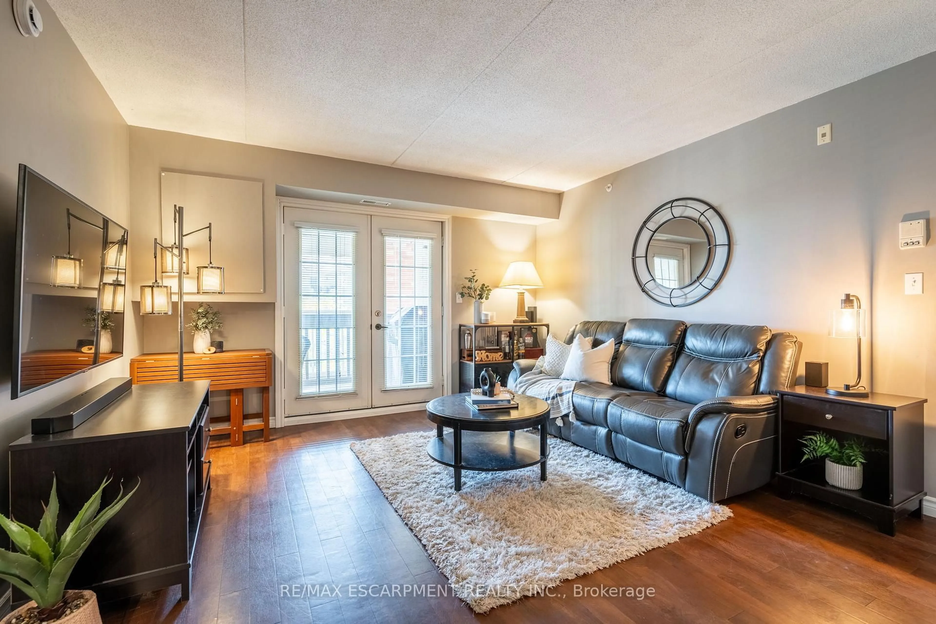 Living room with furniture, wood/laminate floor for 4015 Kilmer Dr #308, Burlington Ontario L7M 4M4
