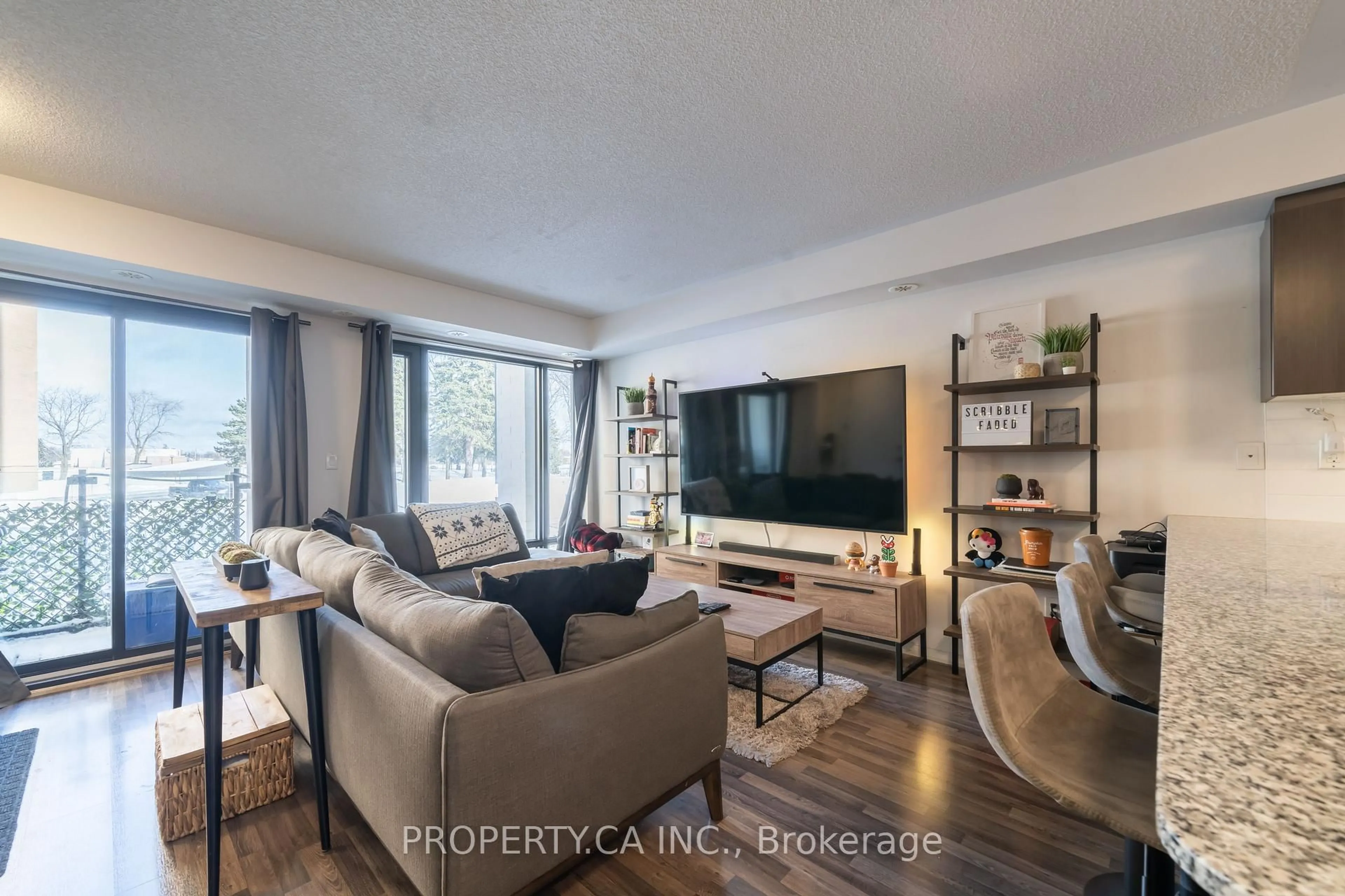 Living room with furniture, wood/laminate floor for 132 Widdicombe Hill Blvd #306, Toronto Ontario M9R 0A6