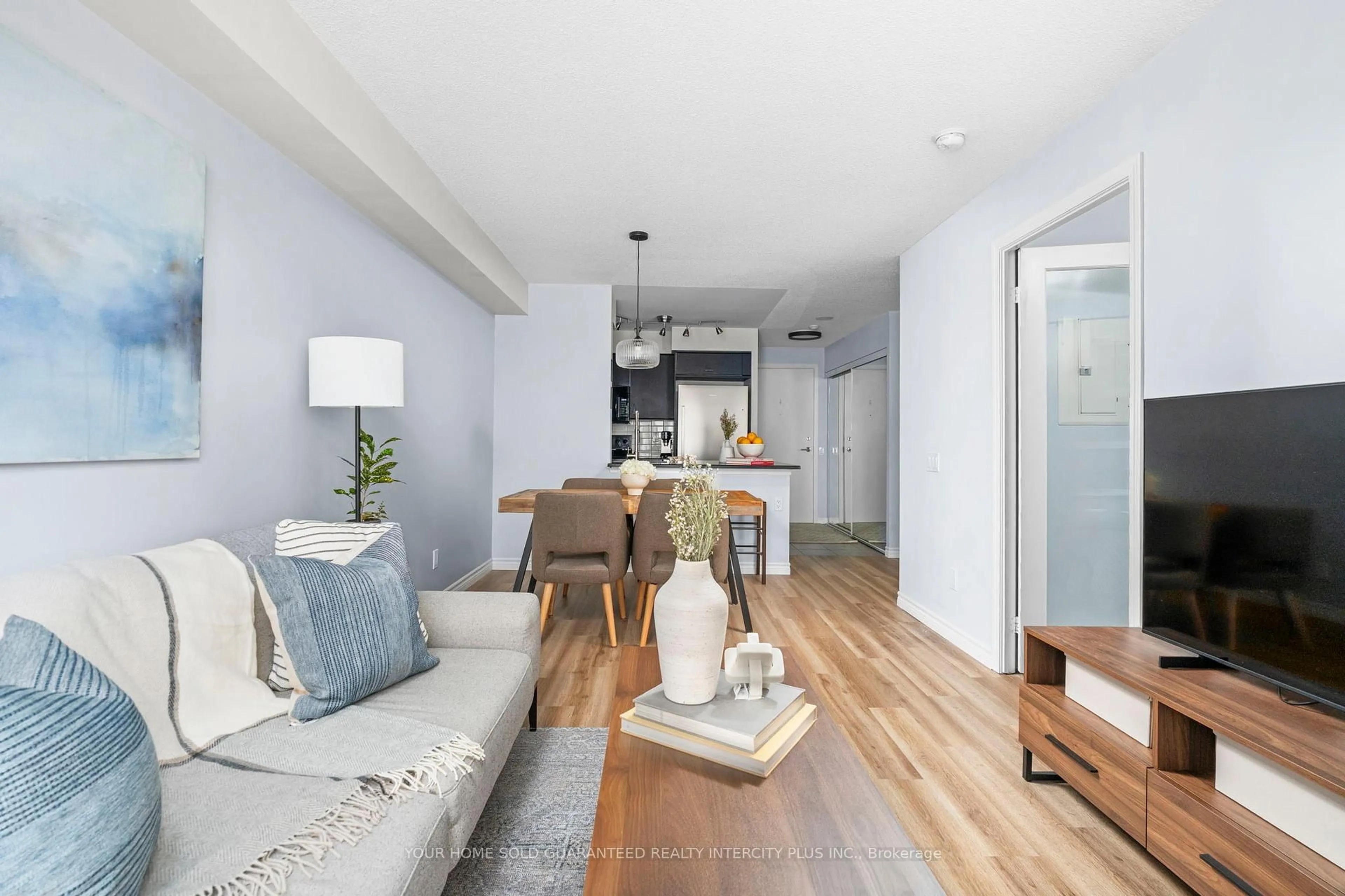 Living room with furniture, wood/laminate floor for 60 Heintzman St #934, Toronto Ontario M6P 5A1