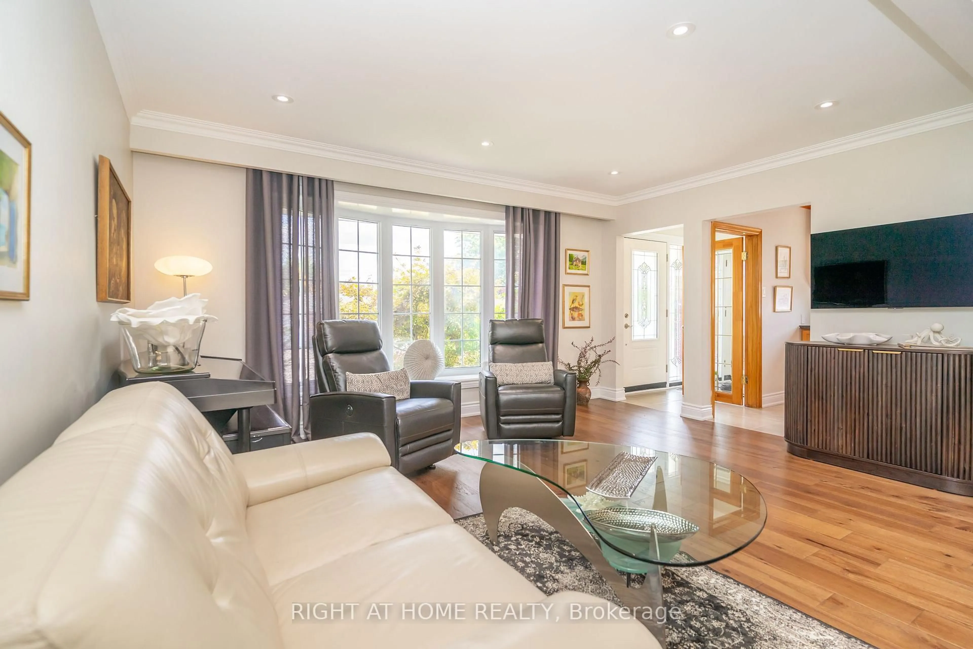 Living room with furniture, wood/laminate floor for 63 Allonsius Dr, Toronto Ontario M9C 3N6