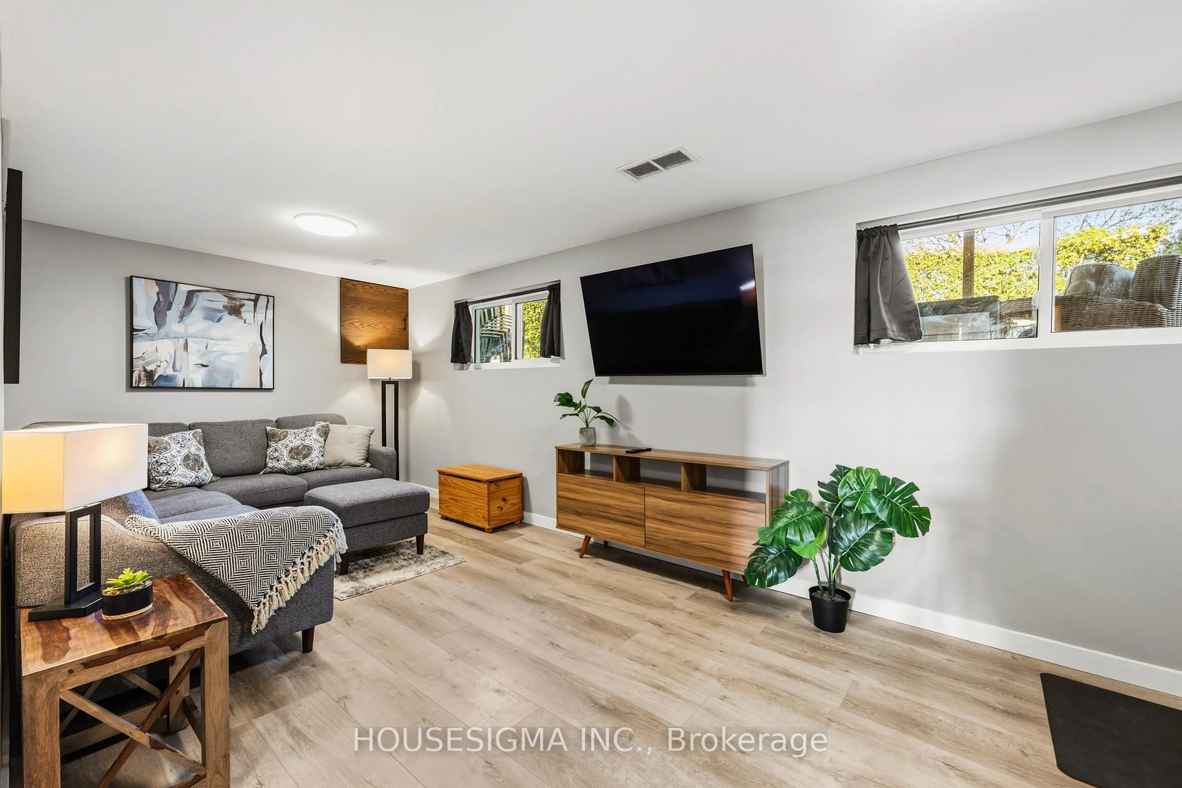 Living room with furniture, wood/laminate floor for 427 Lolita Gdns, Mississauga Ontario L5A 2A8