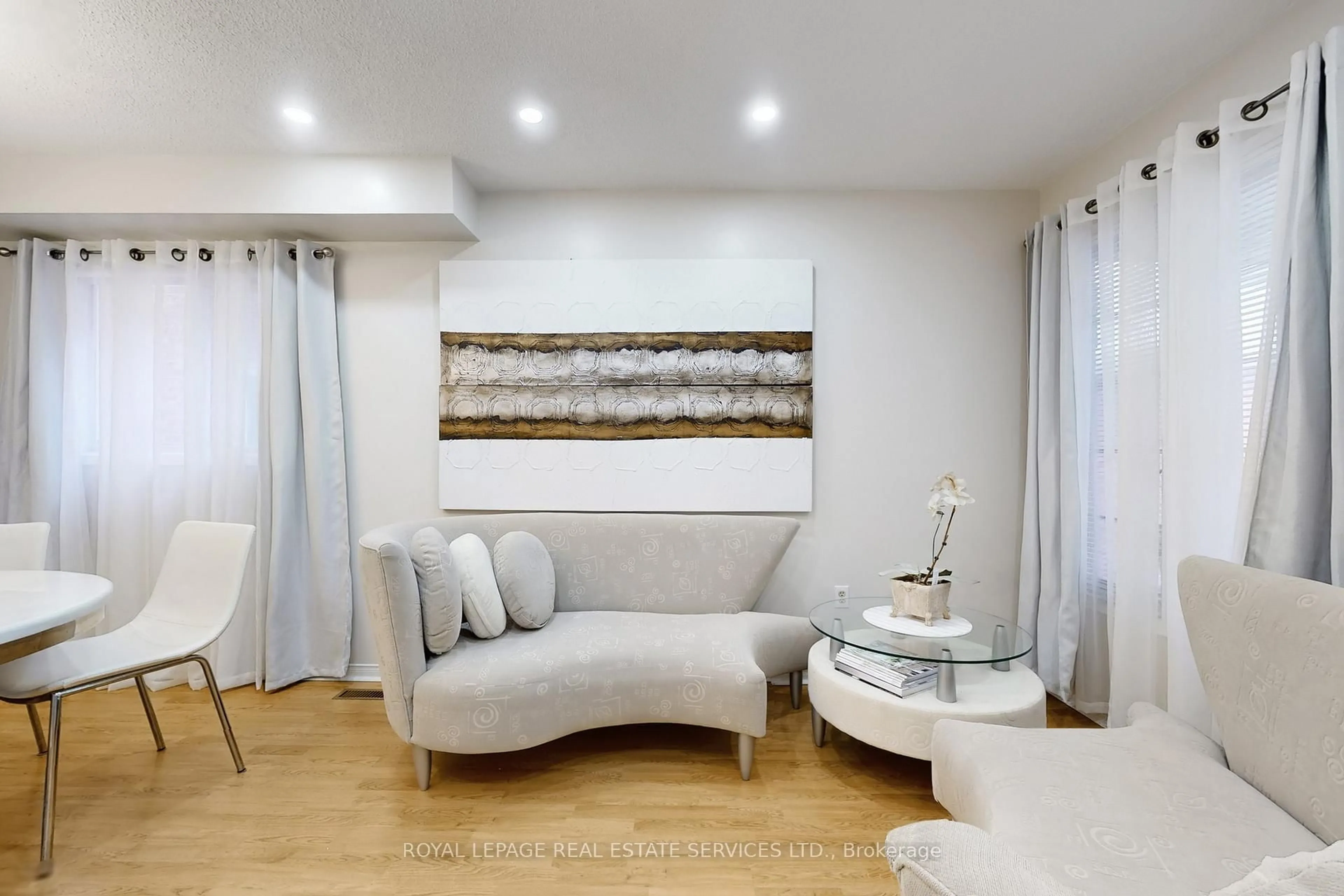 Living room with furniture, wood/laminate floor for 47 Hood Cres, Brampton Ontario L6Y 4S7